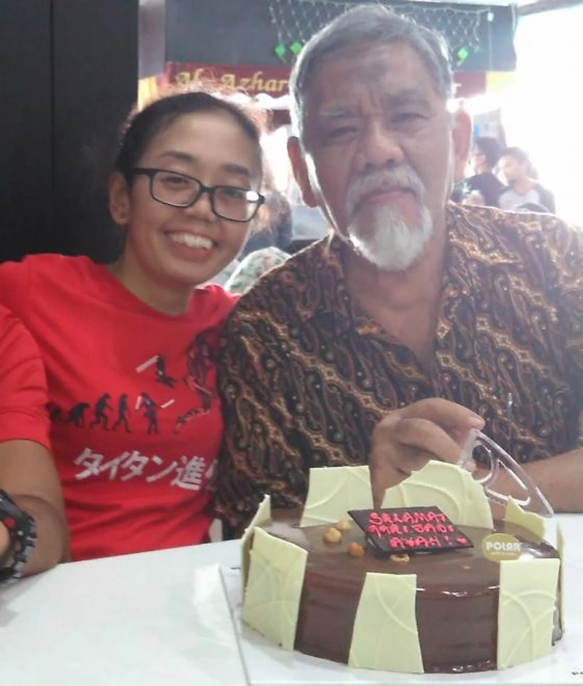 Miss Masturah Salim with her late father.
