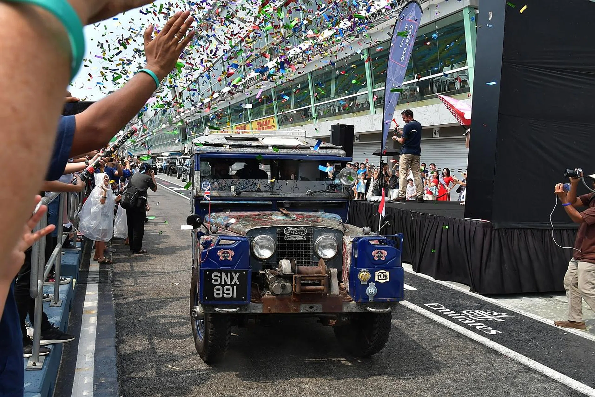 The Last Overland expedition, led by the original "Oxford" Land Rover Series 1, leaving the F1 Pit Building. 