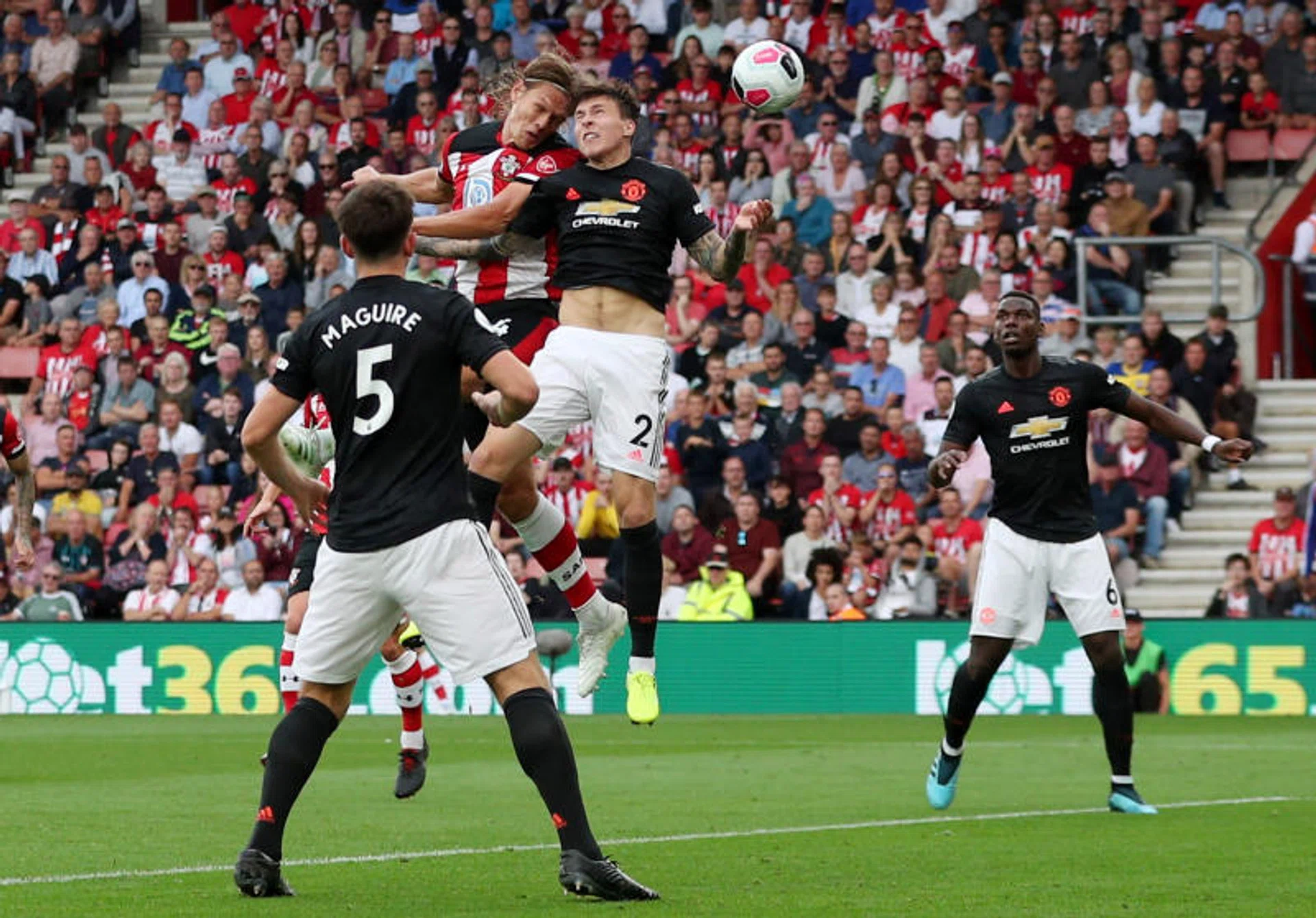 Southampton's Jannik Vestergaard heading in their equaliser despite the challenge of Manchester United defender Victor Lindelof.