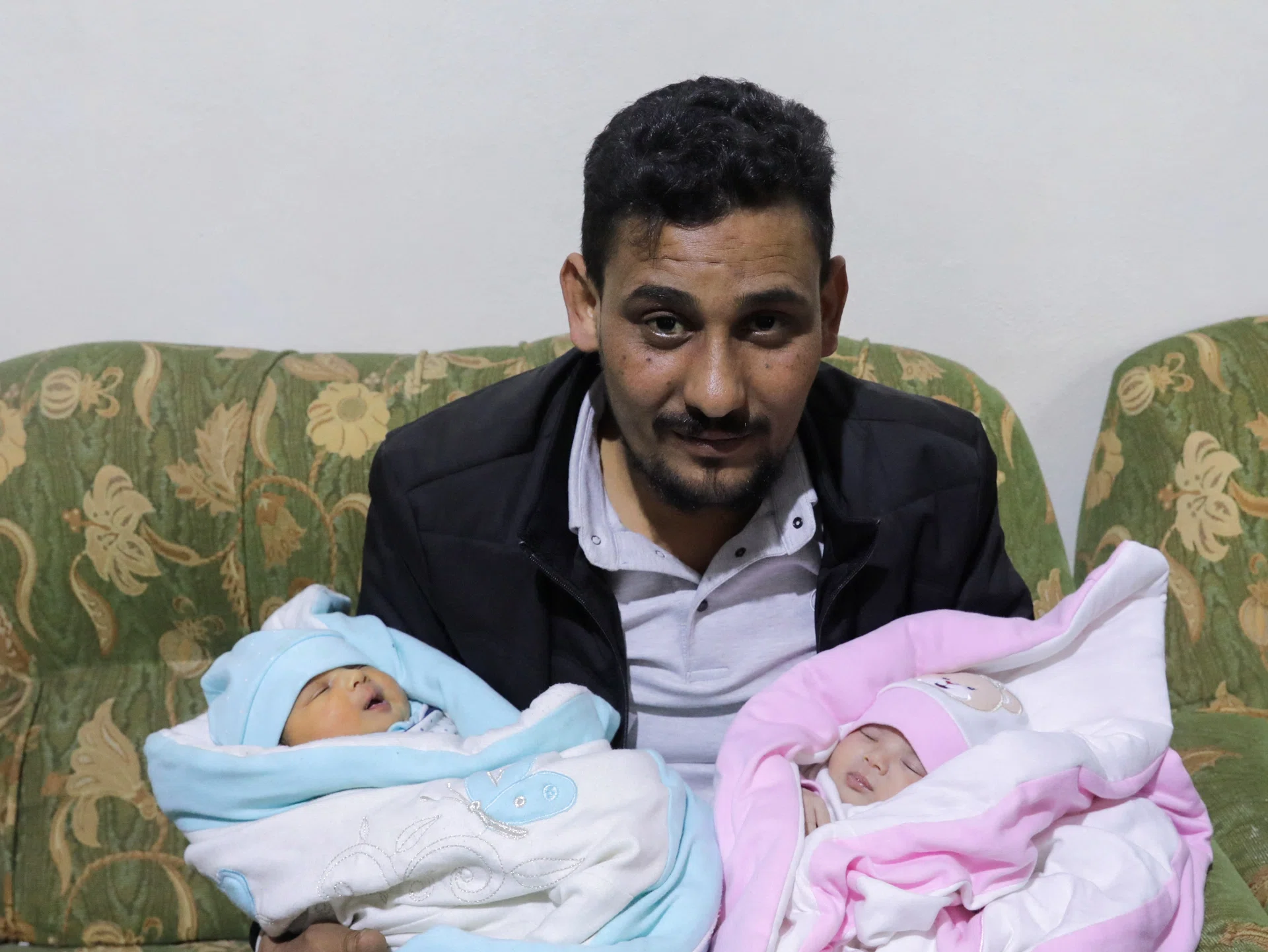 Mr Khalil Al-Sawadi, the uncle-by-marriage of a baby girl born during the Turkey-Syria earthquake, holds her (right) and his own newborn daughter, in Jandaris, Syria, on Feb 18, 2023.

