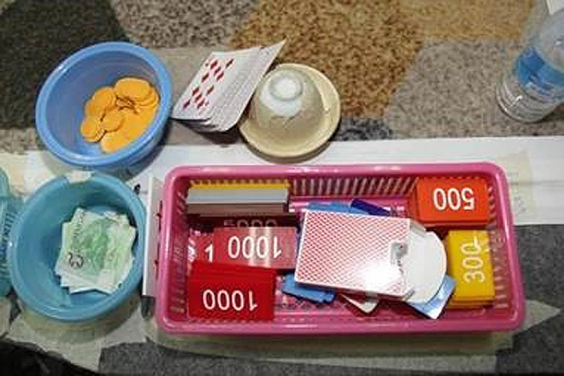 Cash amounting to more than $60,000 and gambling-related paraphernalia seized by the police. 