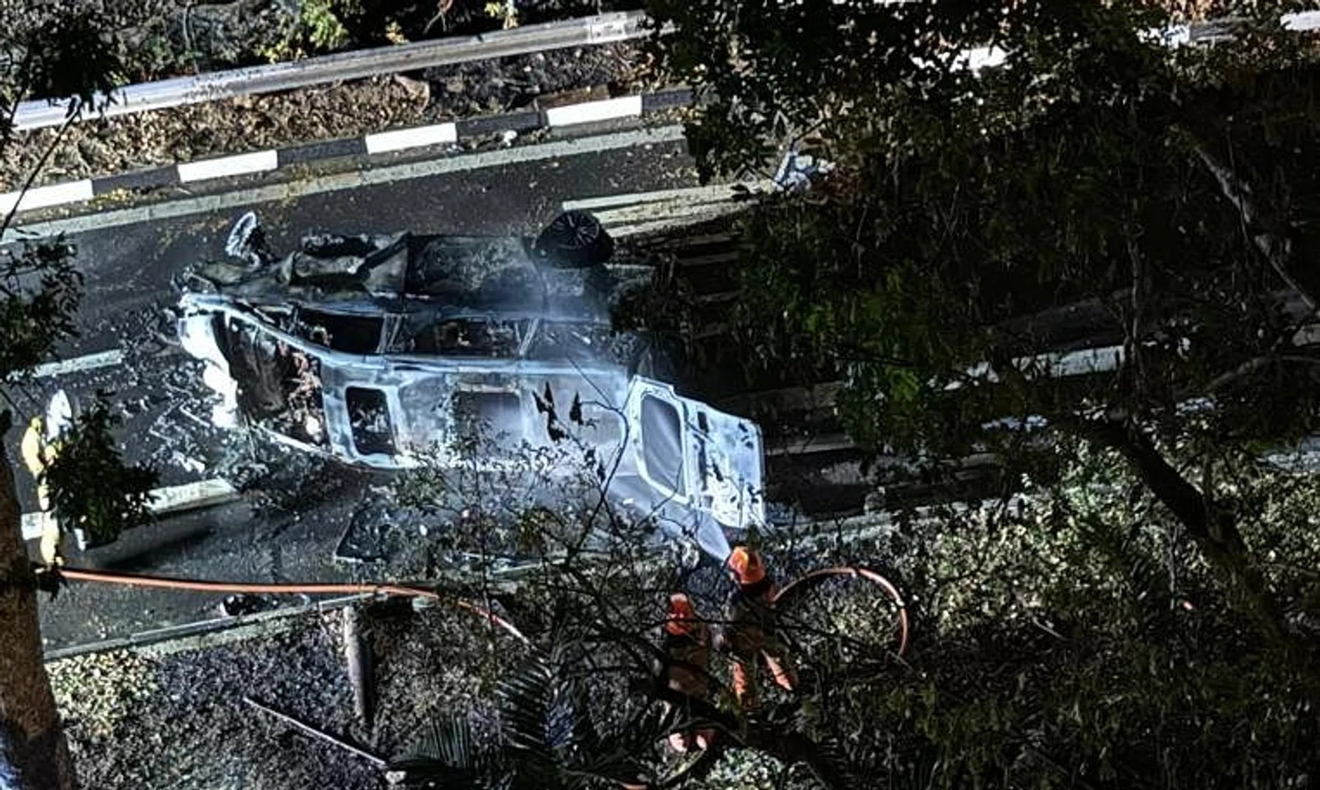 The wreck of the seven-seater MPV after SCDF officers extinguished the blaze with a water jet.