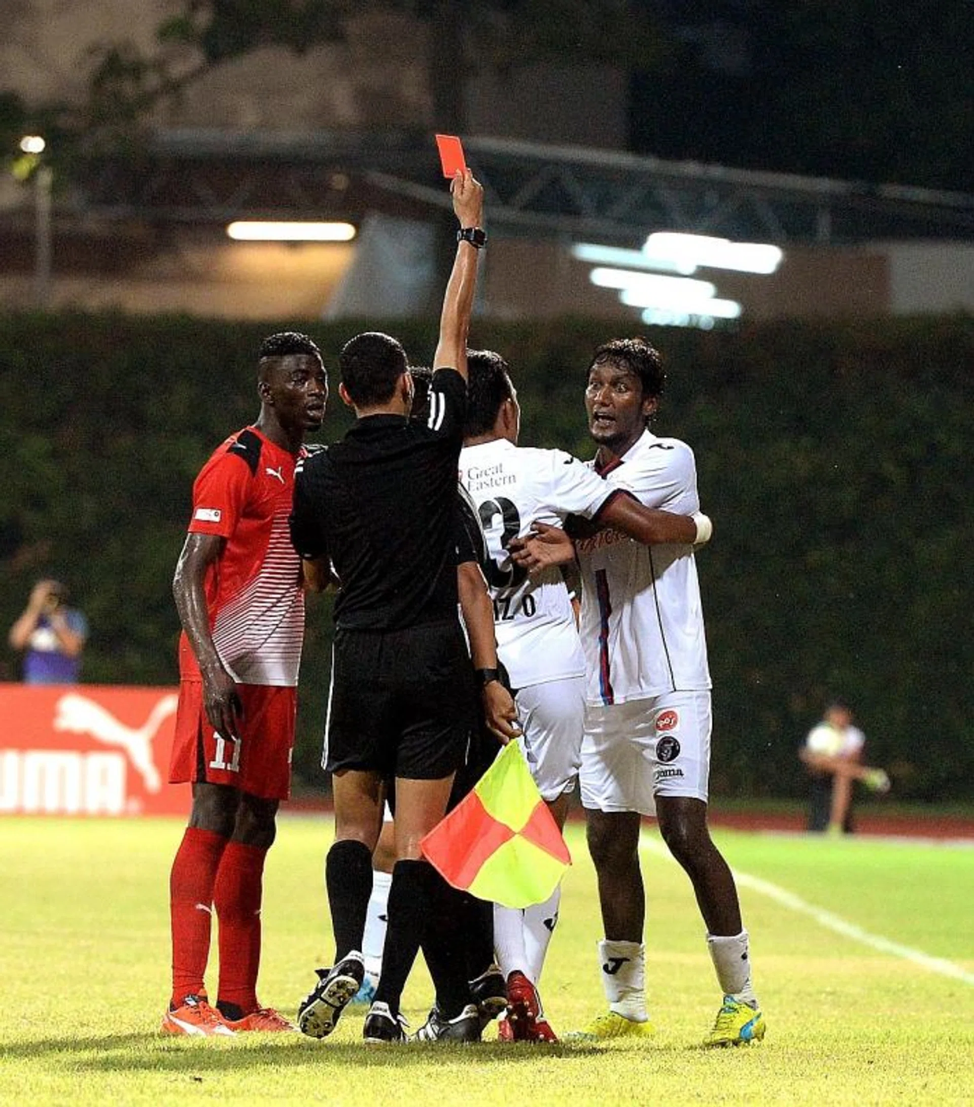 MARCHING ORDERS: Warriors' Madhu Mohana (far right) was sent off for allegedly swinging an arm at Home United forward Irfan Fandi last month.