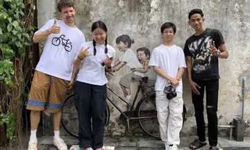 Kids who inspired Penang's iconic murals reunite with artist