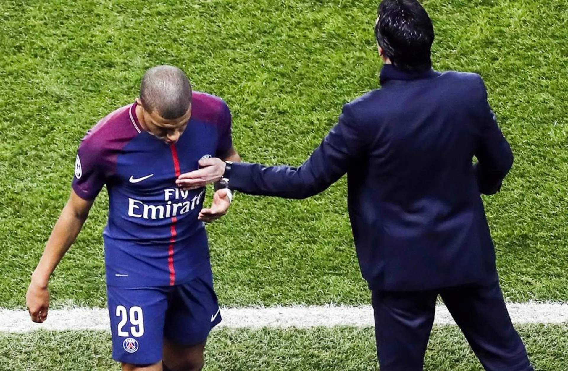 Paris Saint-Germain coach Unai Emery (right) giving striker Kylian Mbappe a pat. 