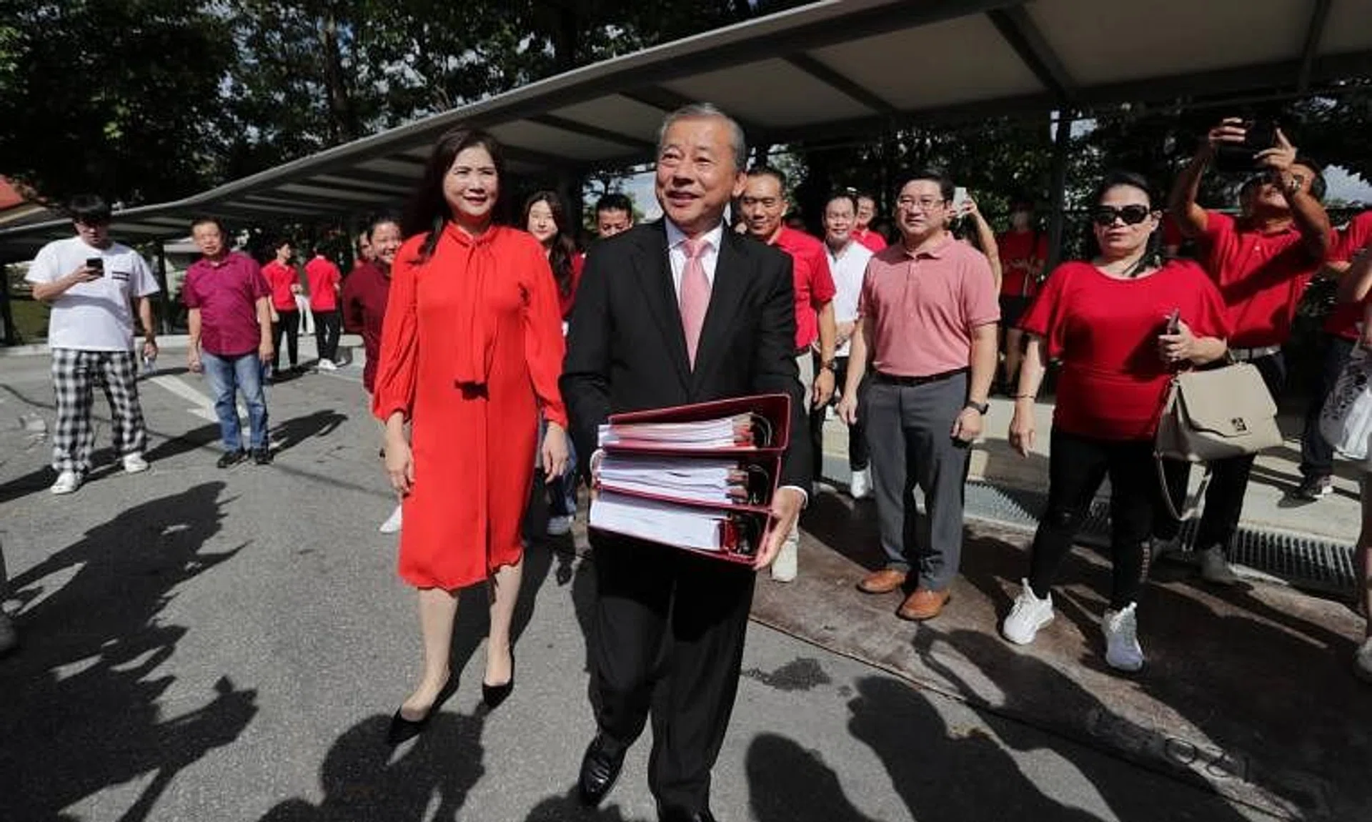 Presidential hopeful George Goh, together with his wife Lysa Sumali, on his way to submit his presidential election eligibility forms on Aug 4.