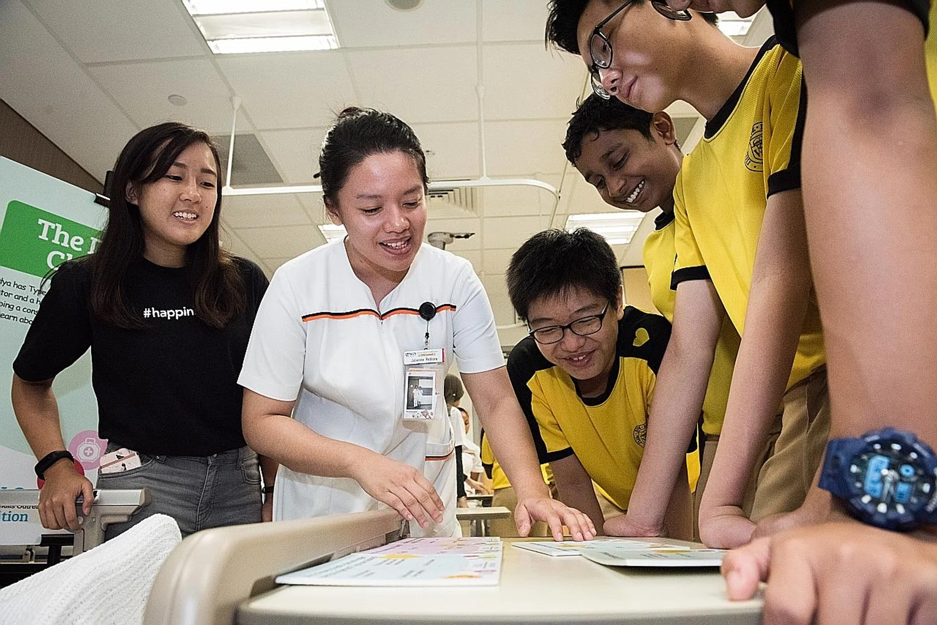 Ms Julienne Reblora teaching the students from Victoria School at one of the exhibition stations. 