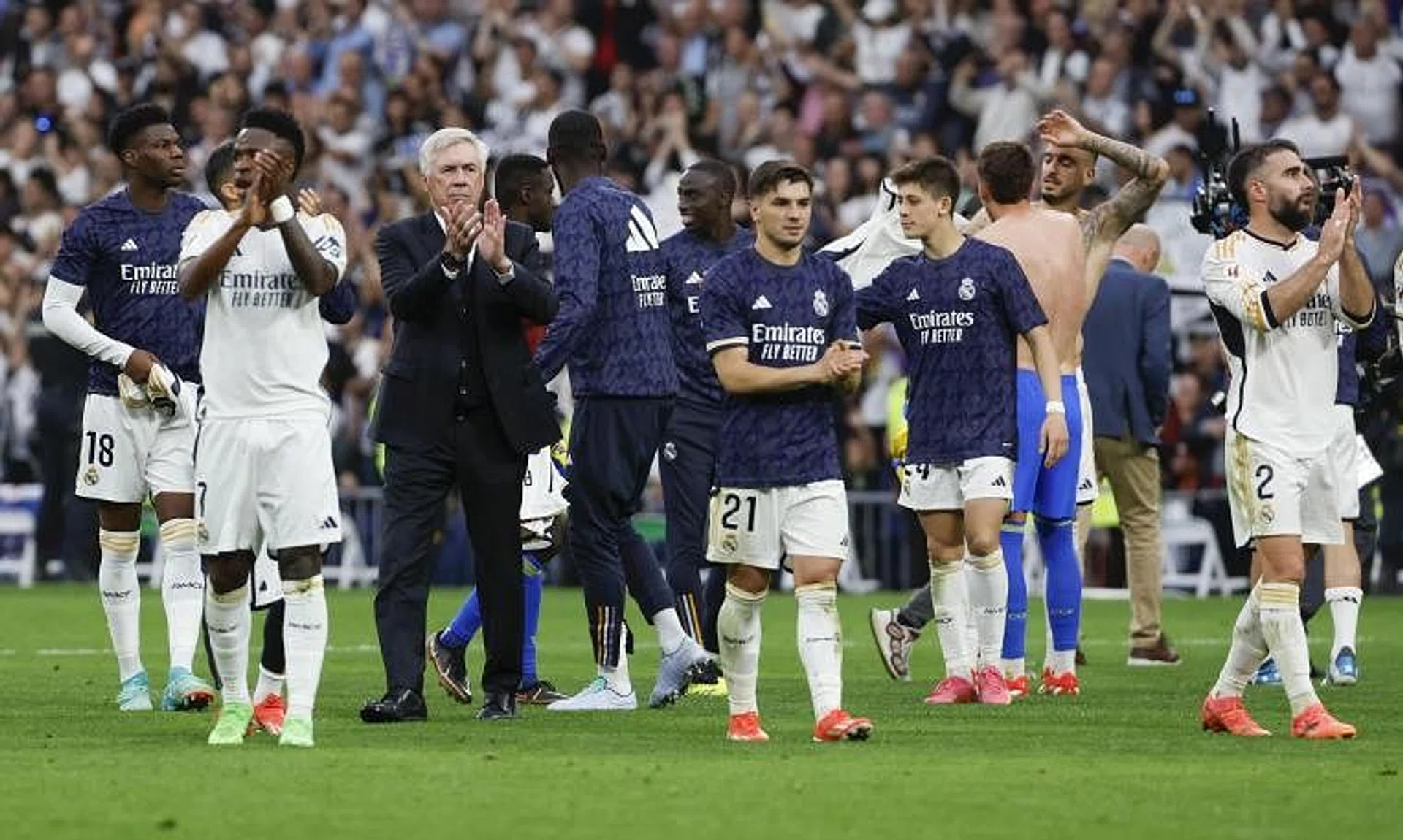 Players of Real Madrid and head coach Carlo Ancelotti applaud supporters as they celebrate winning the Spanish La Liga match against Cadiz and the title.