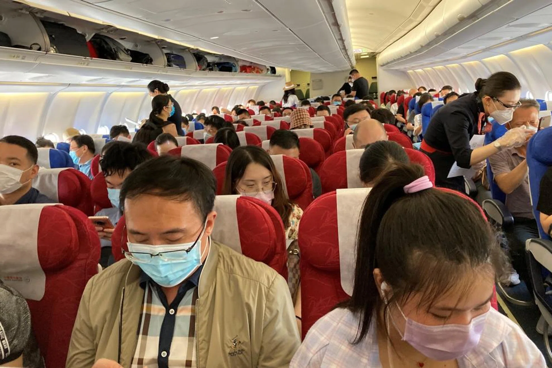Passengers wearing face masks following the coronavirus disease (COVID-19) outbreak are seen on a China Eastern Airlines flight at Shenzhen Baoan International Airport in Shenzhen, Guangdong province, China May 19, 2020.