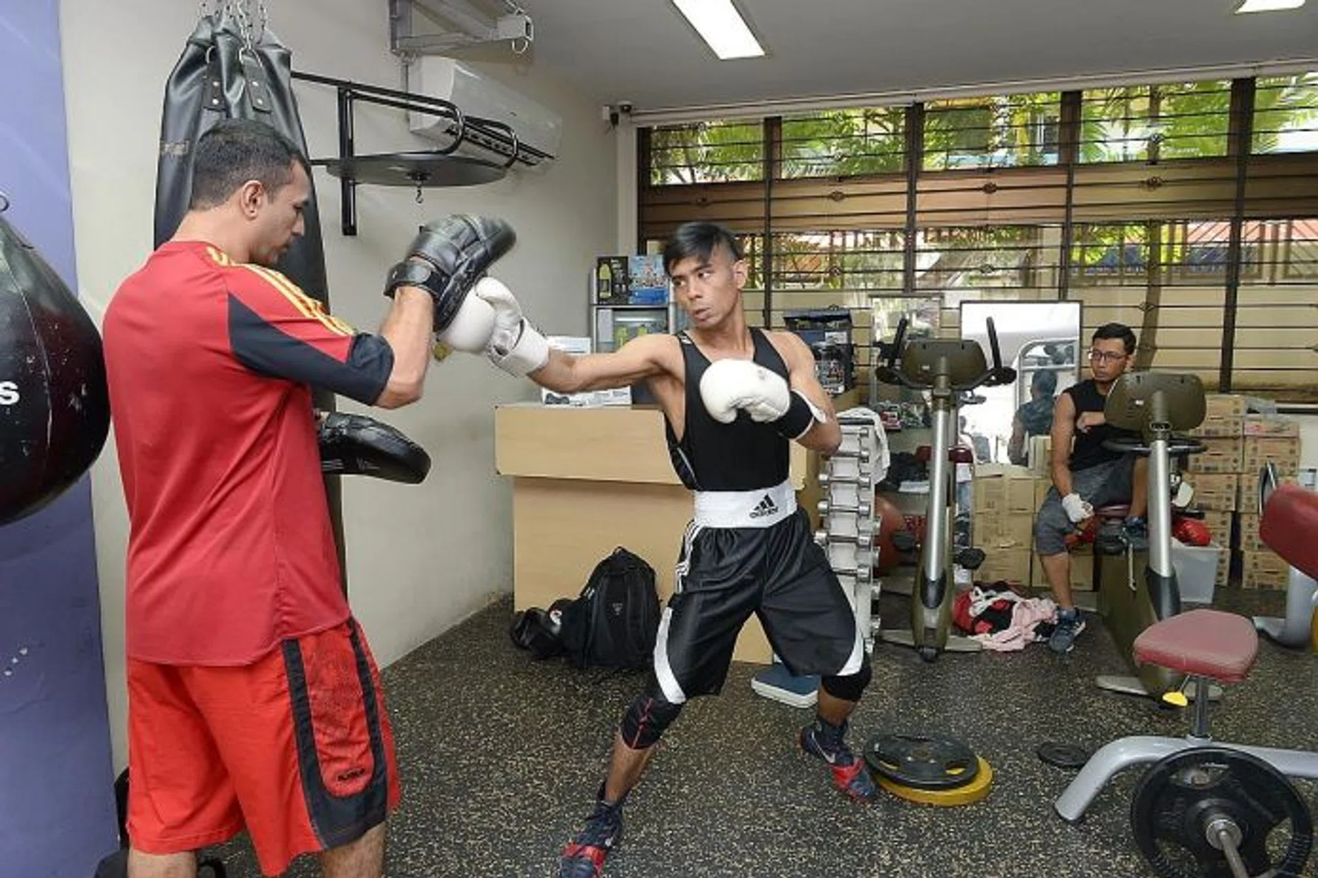 HARD WORK: Mr Muhammad Muslihin Omar (centre) is one of the four students Mr Mohamed Zafar Hussein Malik (in red) trains for free.