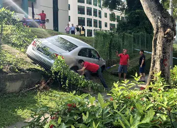 Car slides down slope at school
