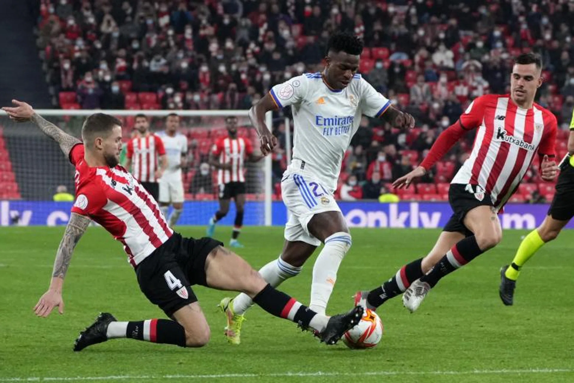 Athletic Bilbao's Inigo Martinez (left) tackles Real Madrid's Vinicius Junior (centre) during the Spanish Copa del Rey quarter-final match in Bilbao, on Feb 3, 2022.
