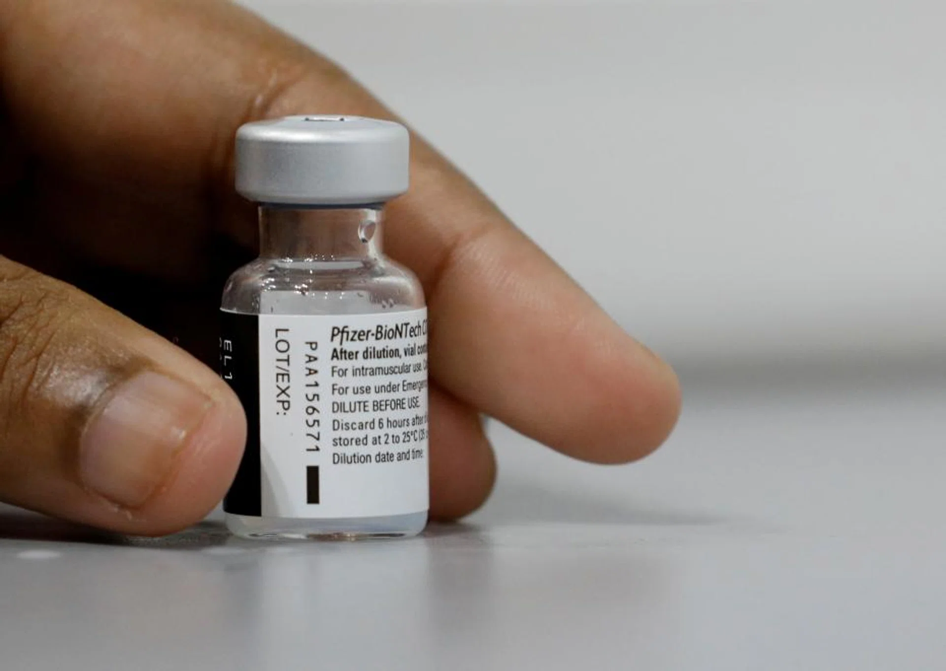 A medical worker prepares to dilute a vial of Pfizer-BioNTech vaccine at a coronavirus disease (COVID-19) vaccination center in Singapore March 8, 2021.