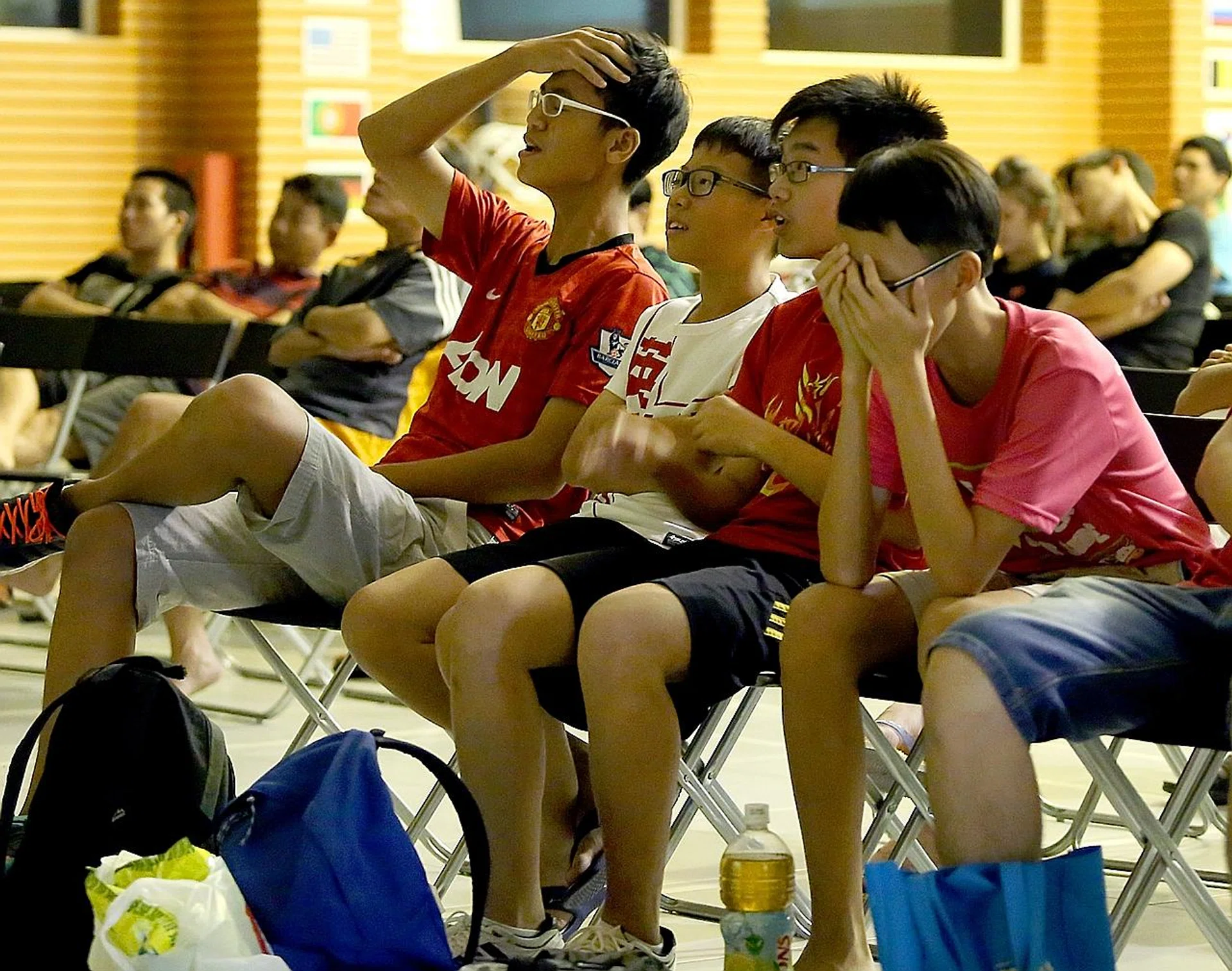 Fans watching a live screening of a World Cup match at a community club in 2014. Many fans TNP spoke to said they will be looking for places that show live-screening this year. 
