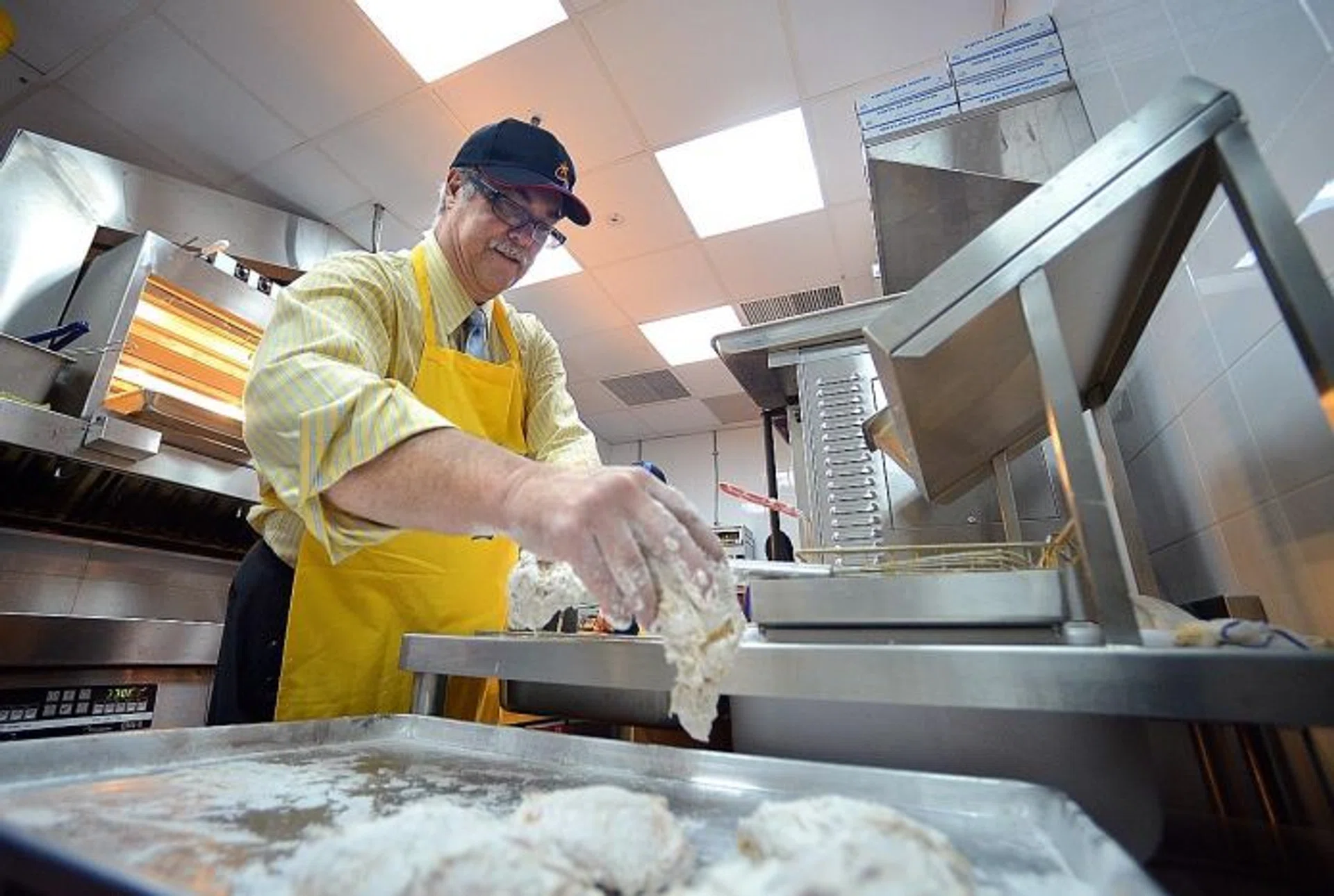 HANDS ON: Texas Chicken CEO Jim Hyatt preparing the fast-food restaurant's signature fried chicken.