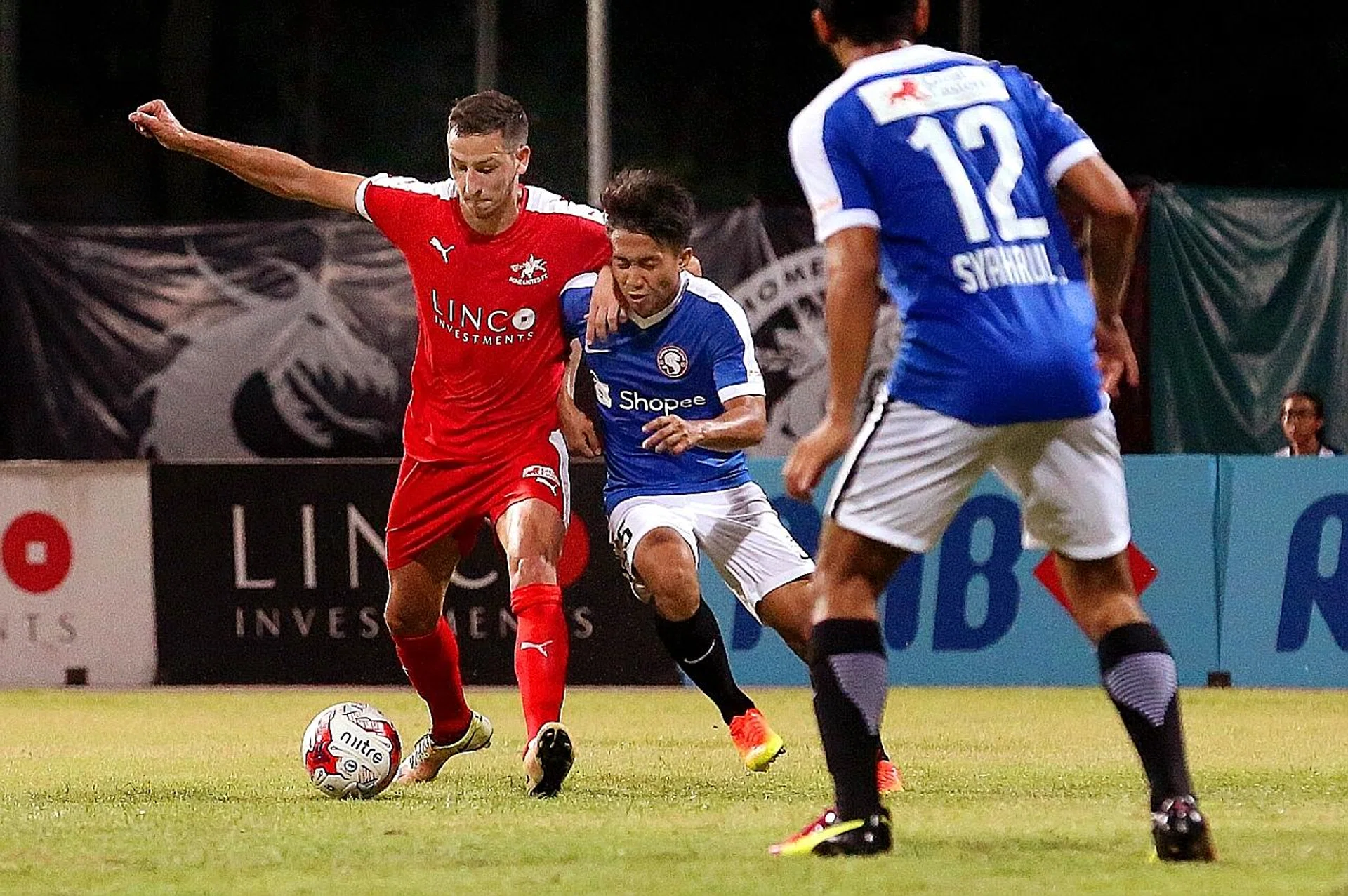 Home's four-goal hero Stipe Plazibat (in red) fending off Garena Young Lions' Rusyaidi Salime.