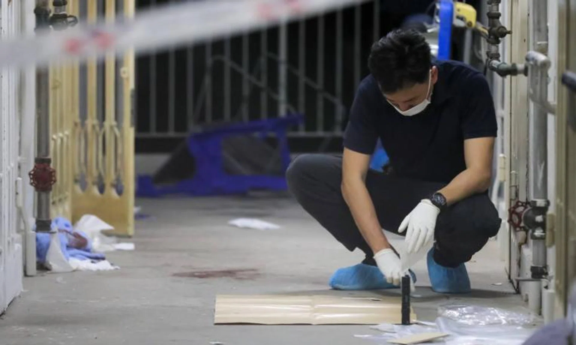 A shooting incident at 33 Bendemeer Road on March 23, 2022. Blood stains can be seen on the floor outside the unit.