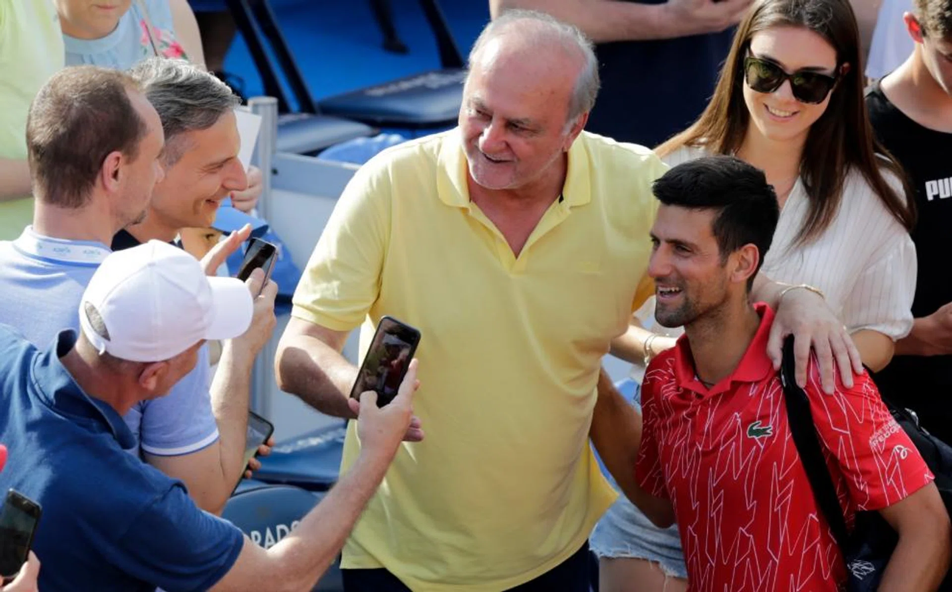 Novak Djokovic (in red) engaging fans at June's Adria Tour tennis tournament in Belgrade, Serbia.