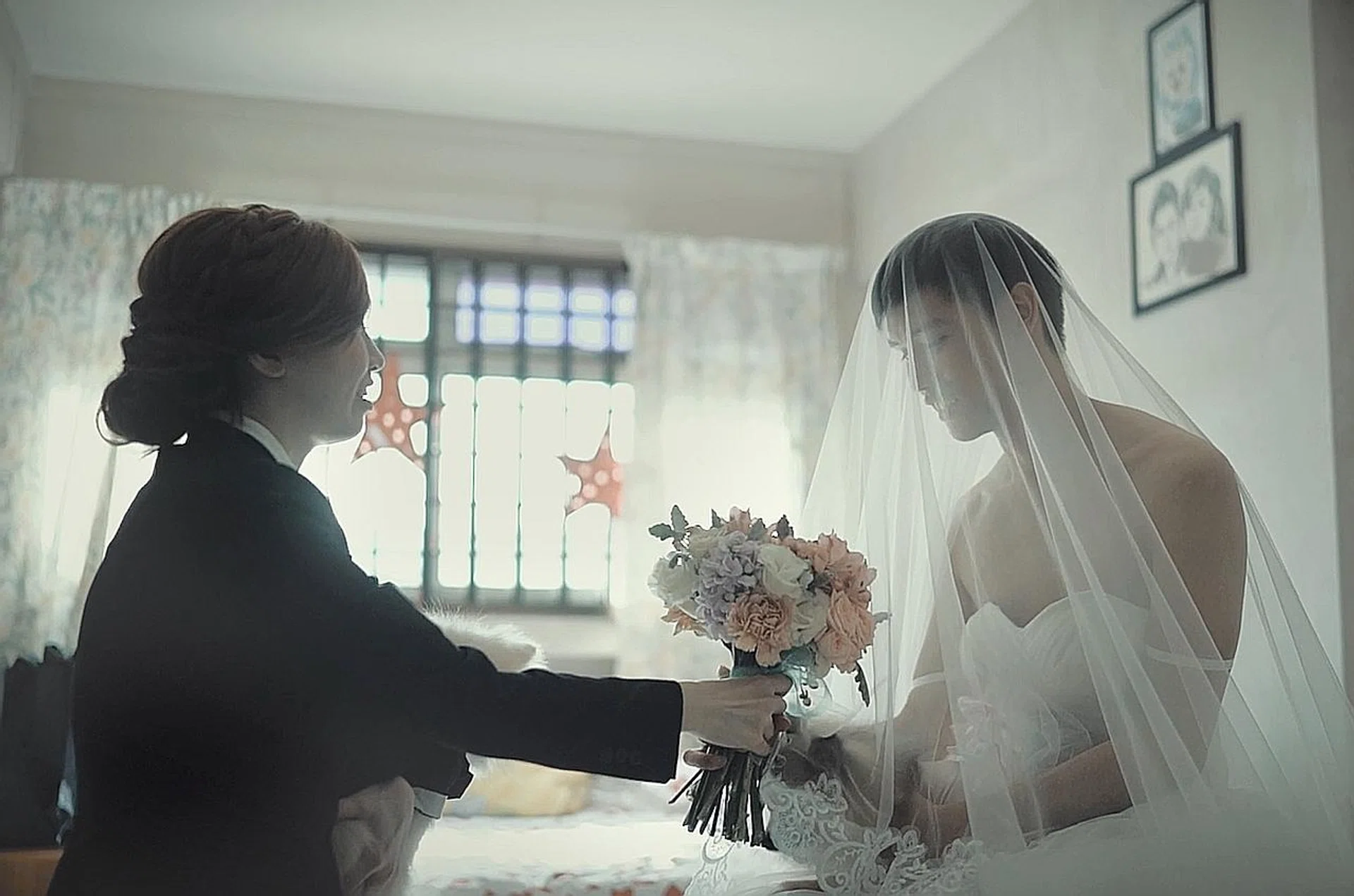 Mr Ho's mother helped him into the dress.