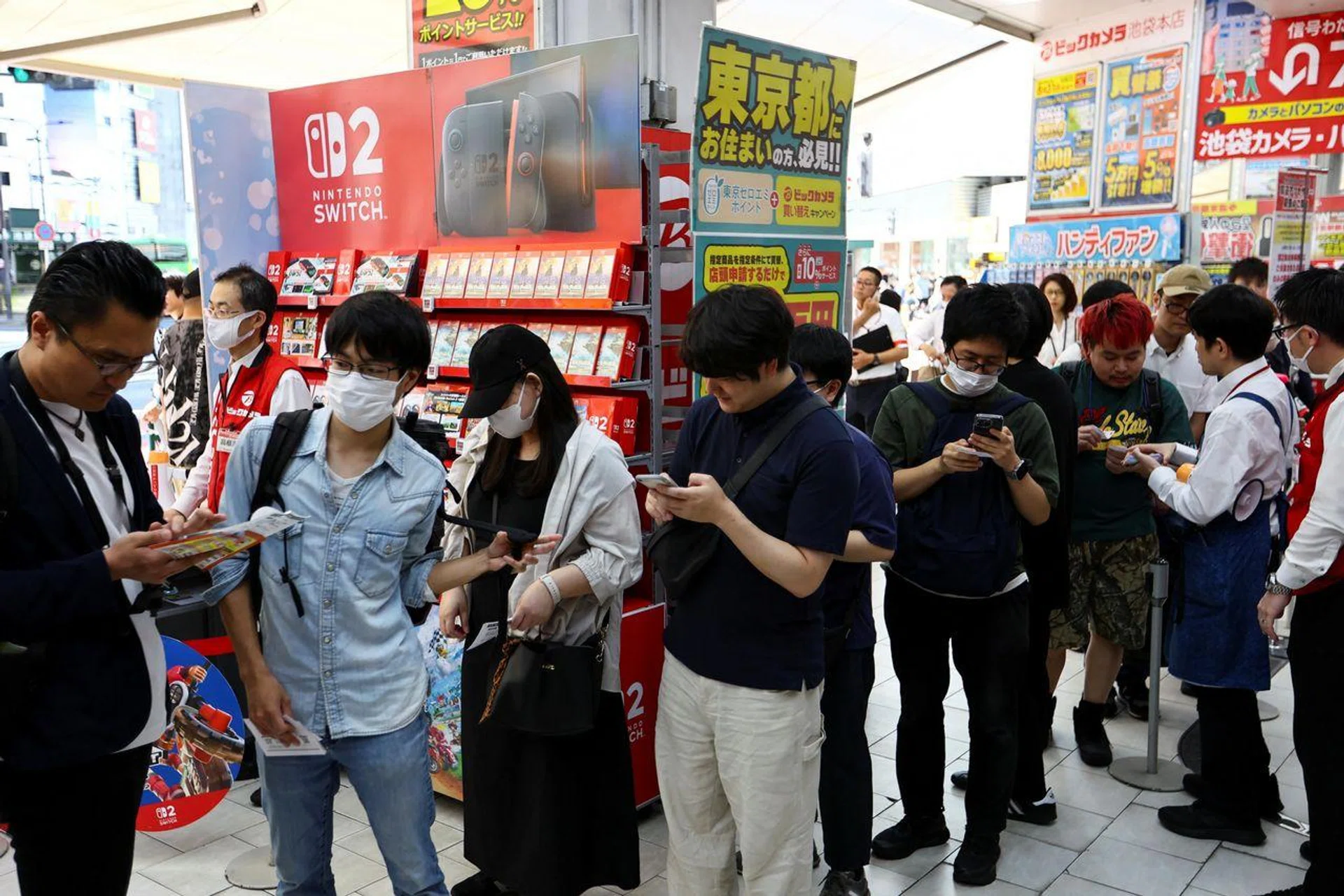 Customers line up to get their hands on the Nintendo Switch 2 gaming device at an electronics store in Tokyo on June 5.