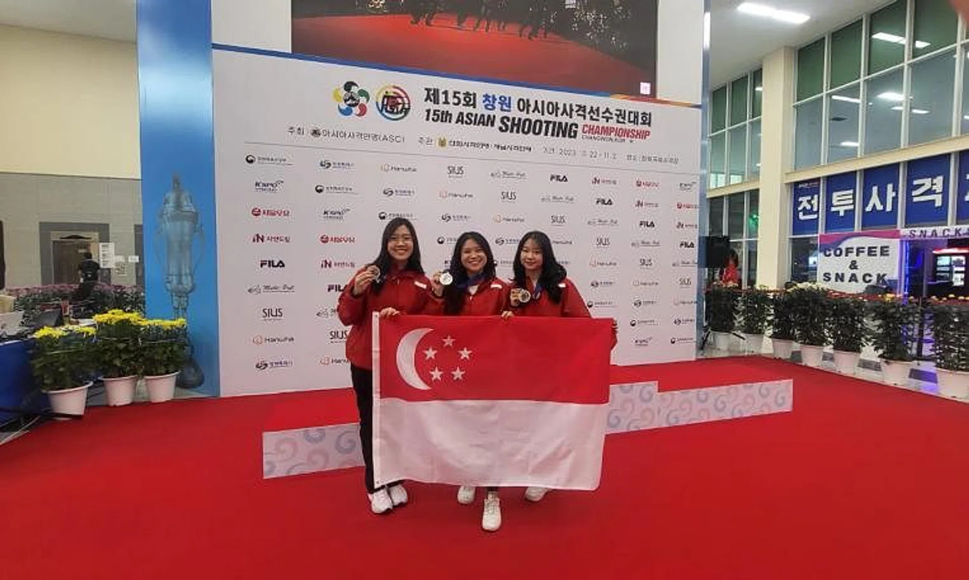 (From left) Singapore shooters Fernel Tan, Martina Veloso and Natanya Tan won a silver medal in the 10m air rifle women's team event.