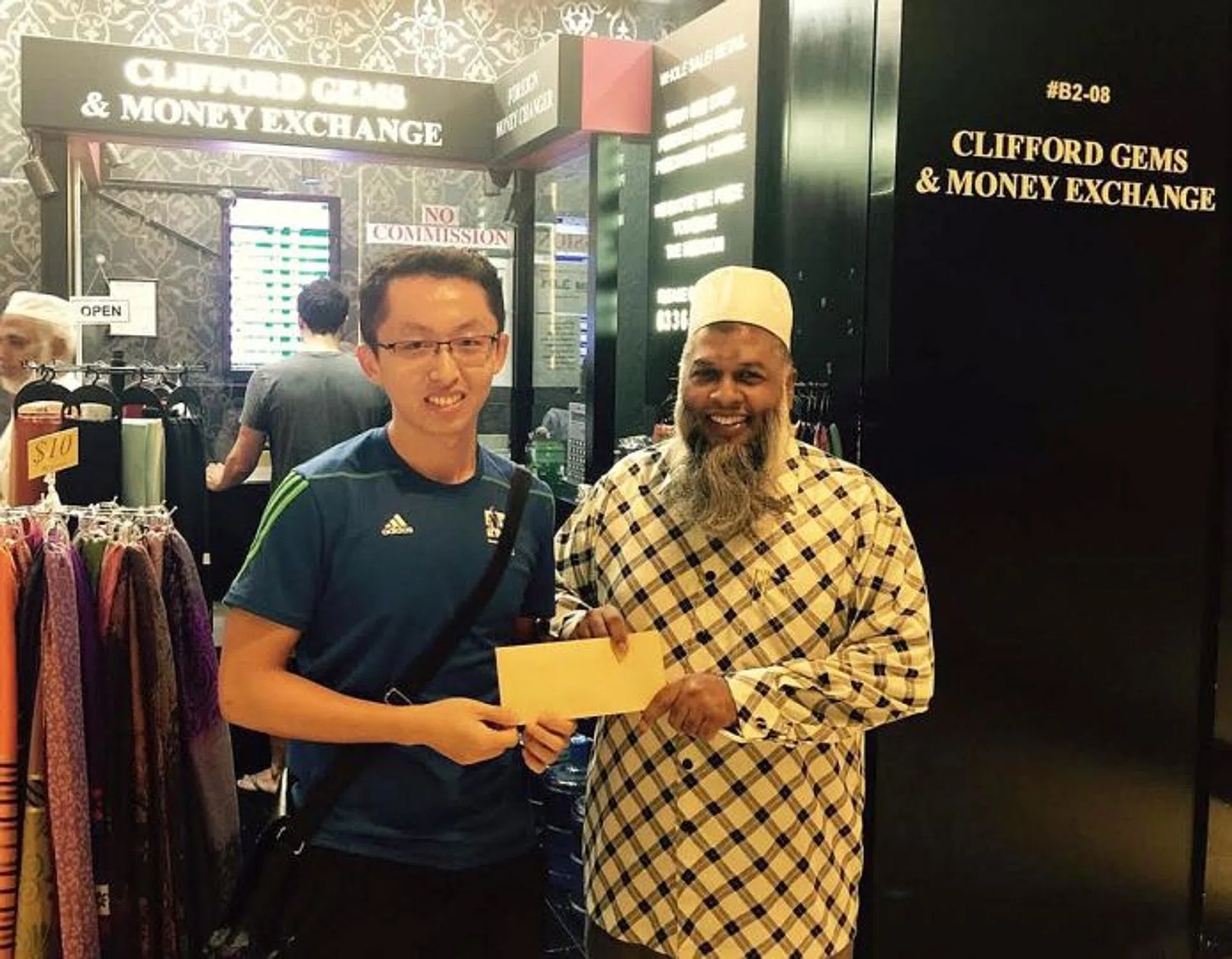 HONEST: Mr Tony Wang (left) being given a token of appreciation by Mr Mohamed Rafeeq for his good deed.