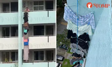 Woman hangs laundry down multiple floors of AMK block