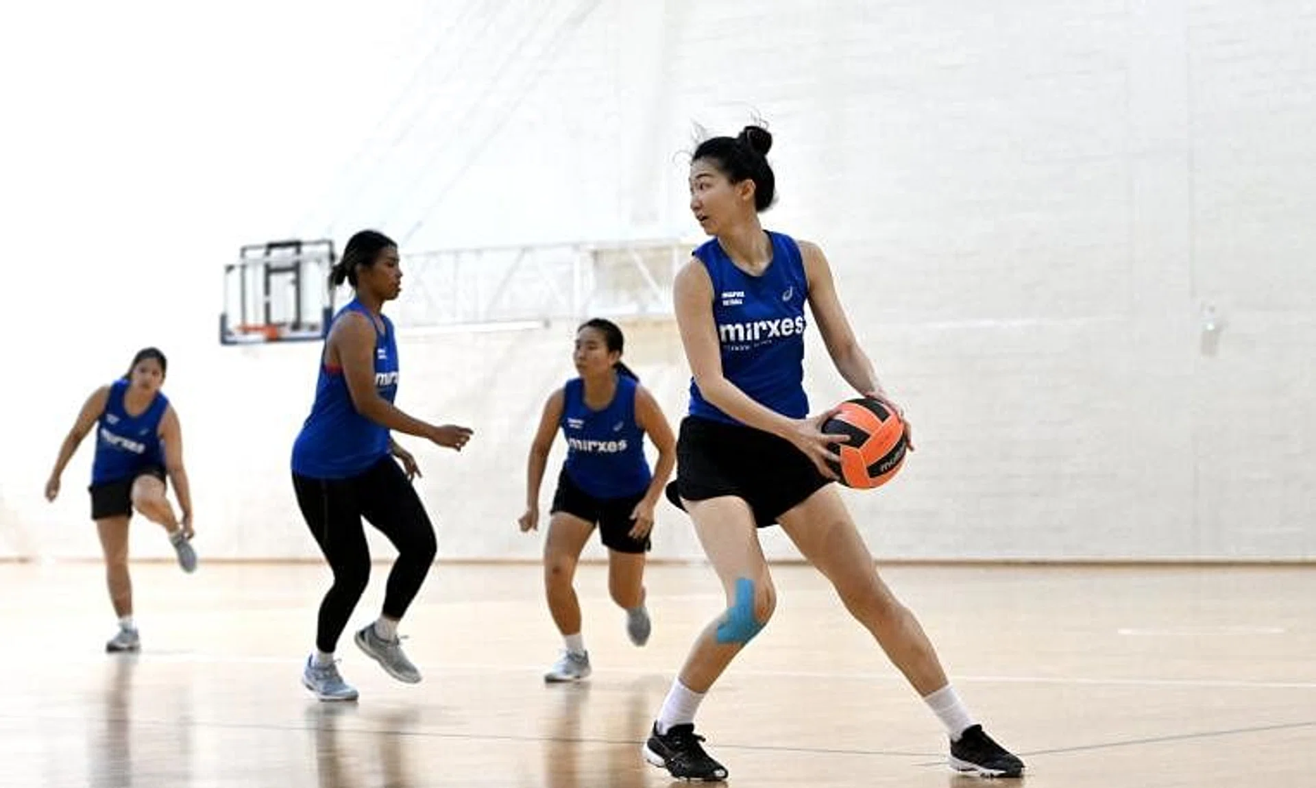 Veteran netballer Charmaine Soh (with ball) is making her return to competitive action after recovering from an anterior cruciate ligament injury. 