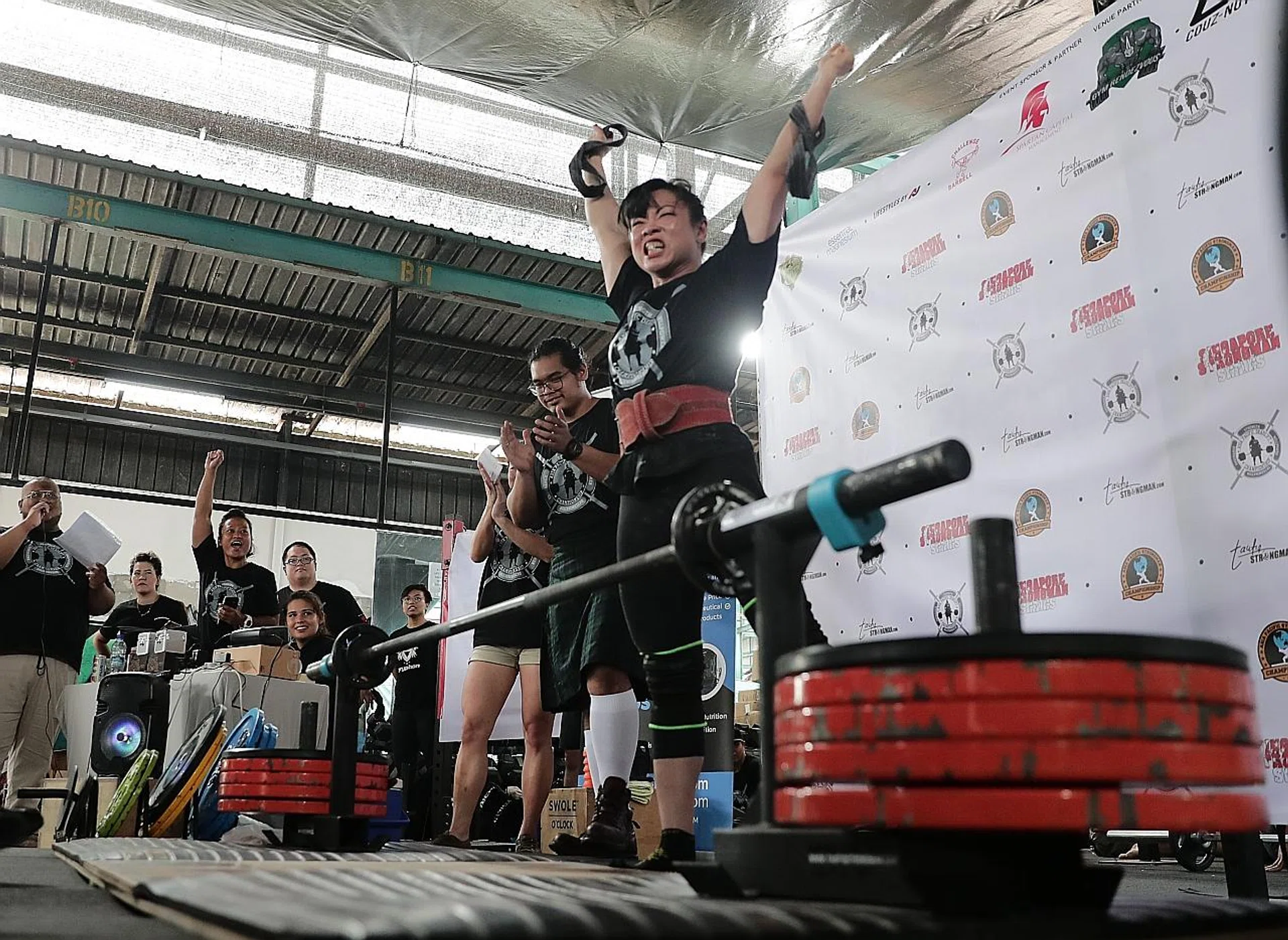 Personal trainer Barbara Chng celebrates after lifting her personal best of 260kg.