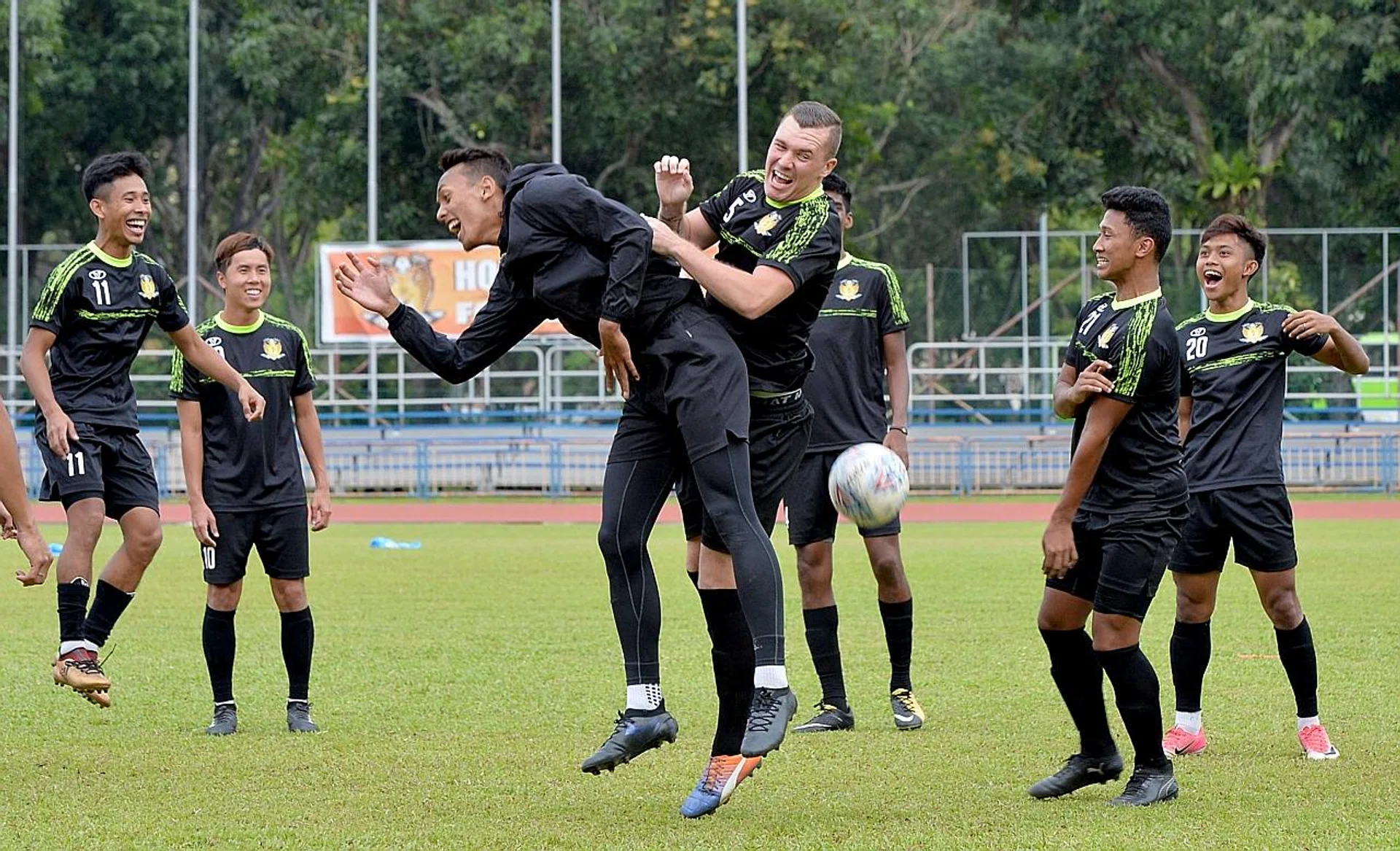 Hougang United's new defender Adam Mitter (far right) in an aerial challenge with a teammate at training.