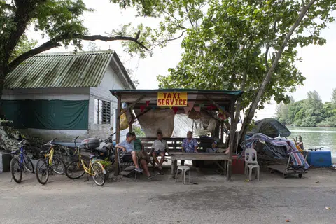 Taxi van drivers gathering at the pick-up point on Pulau Ubin's