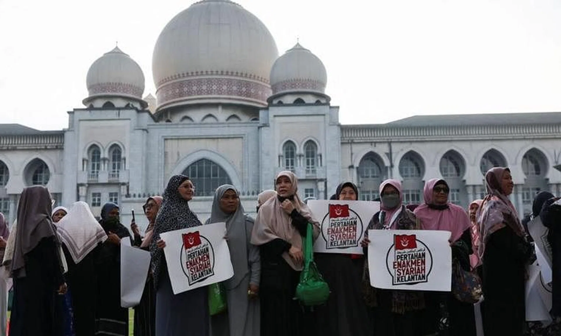 Women protest outside the Palace of Justice on the day the country's federal court delivers verdict in Kelantan state, in Putrajaya, on Feb 9.