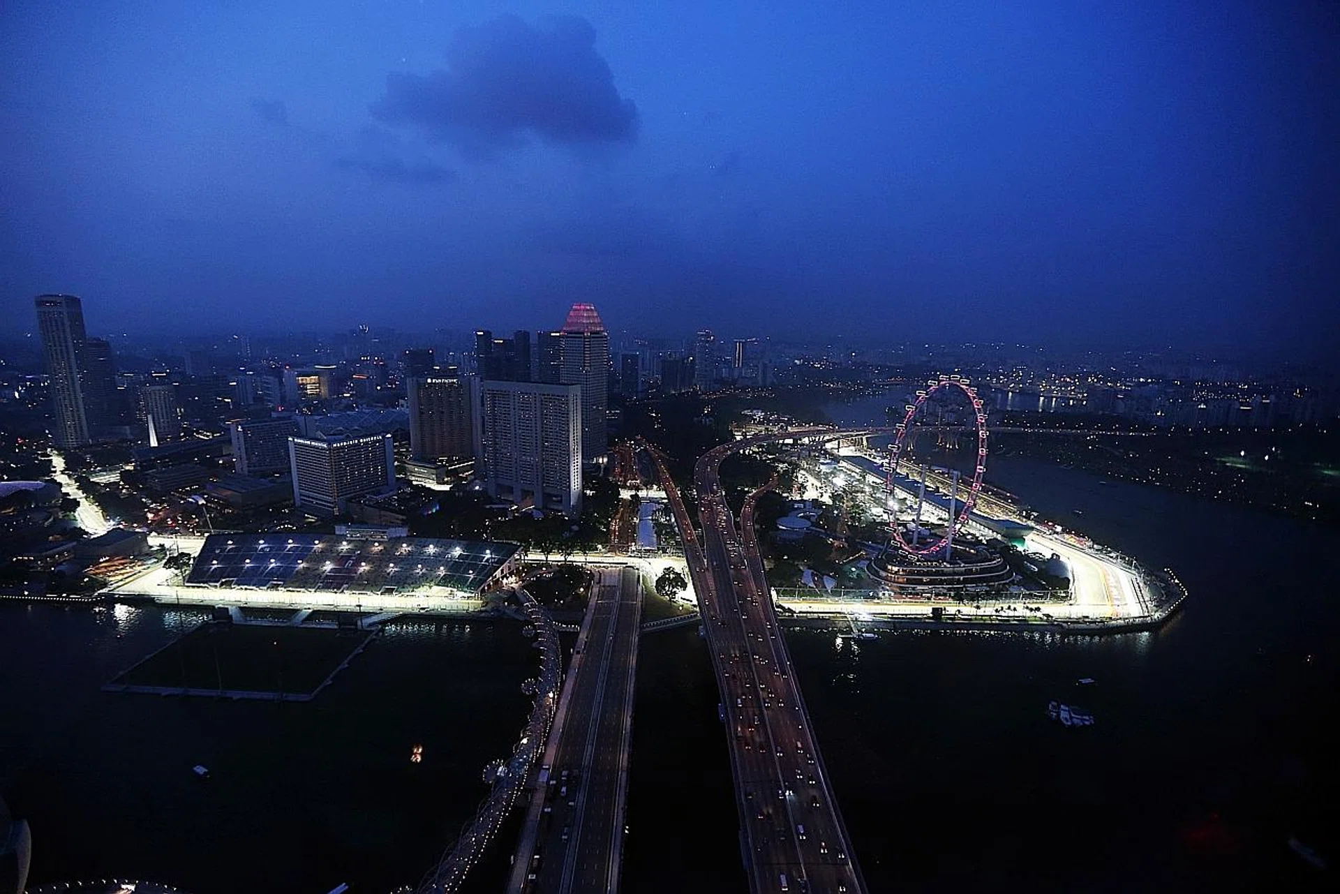 The Formula One street circuit glowing as night falls on Singapore, as seen from Marina Bay Sands. 