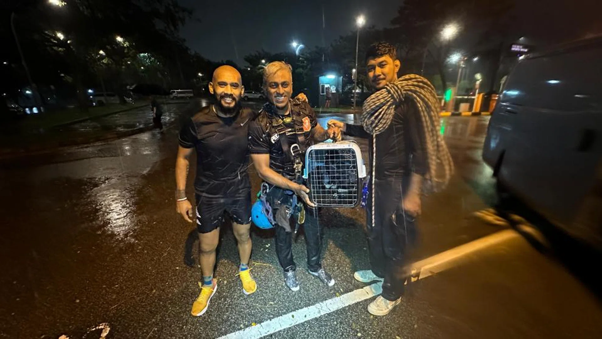 (From left) Mr Zul Awab, Mr Mohammed Ali and Mr Syafiq Faiqsyazwi with the rescued kitten before handing it over to AVS. 