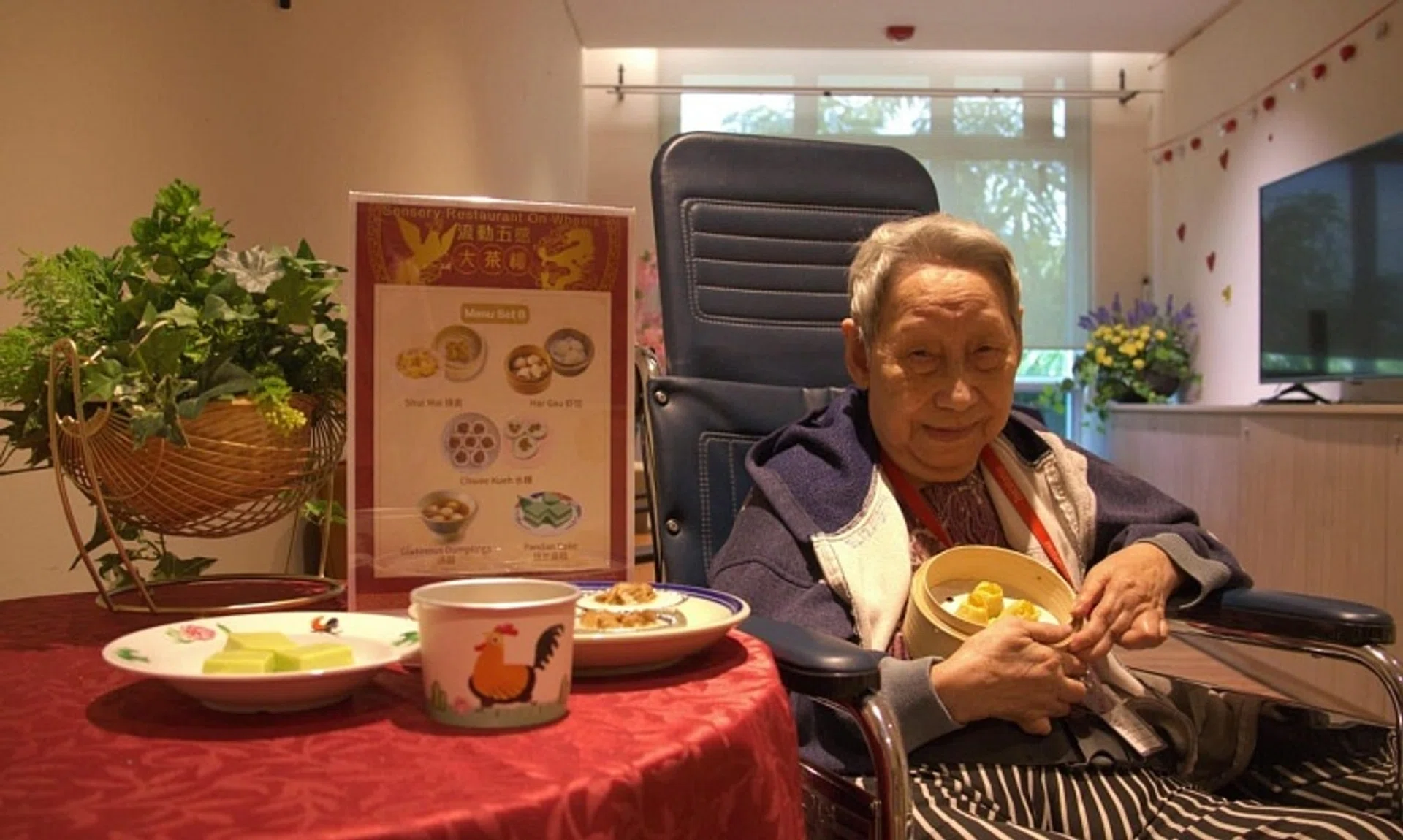 Madam Elizabeth Loh with softmeal siu mai, chwee kueh and pandan cake at The Salvation Army Peacehaven Nursing Home.