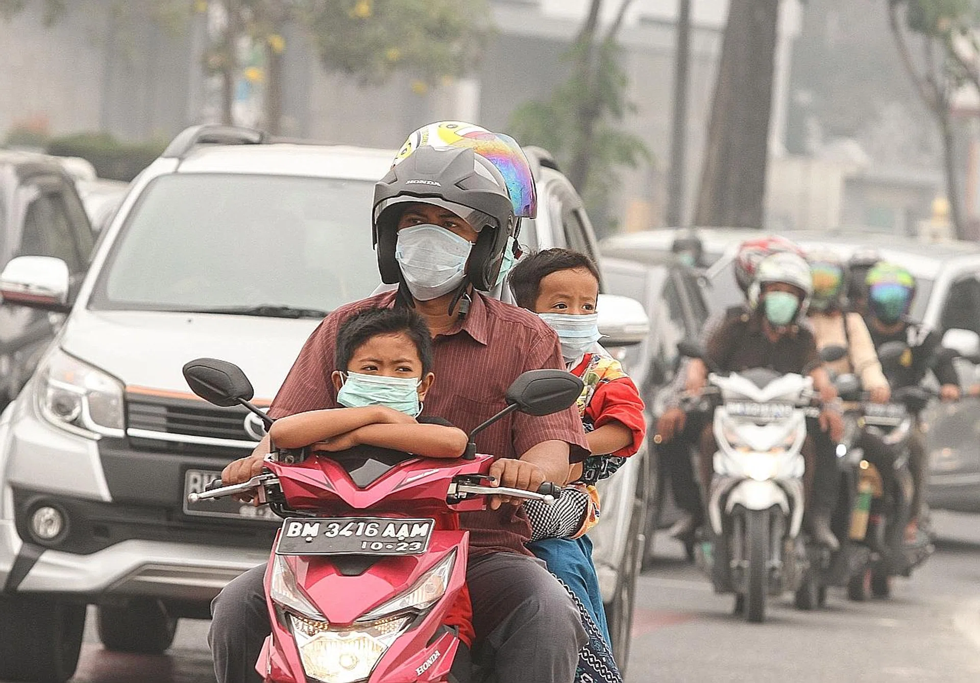 Motorcyclists wear masks amid the haze in Pekanbaru, Indonesia. 