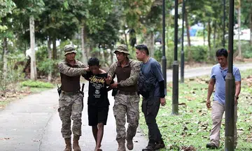 Man banned from entering Singapore among 5 arrested in forested area