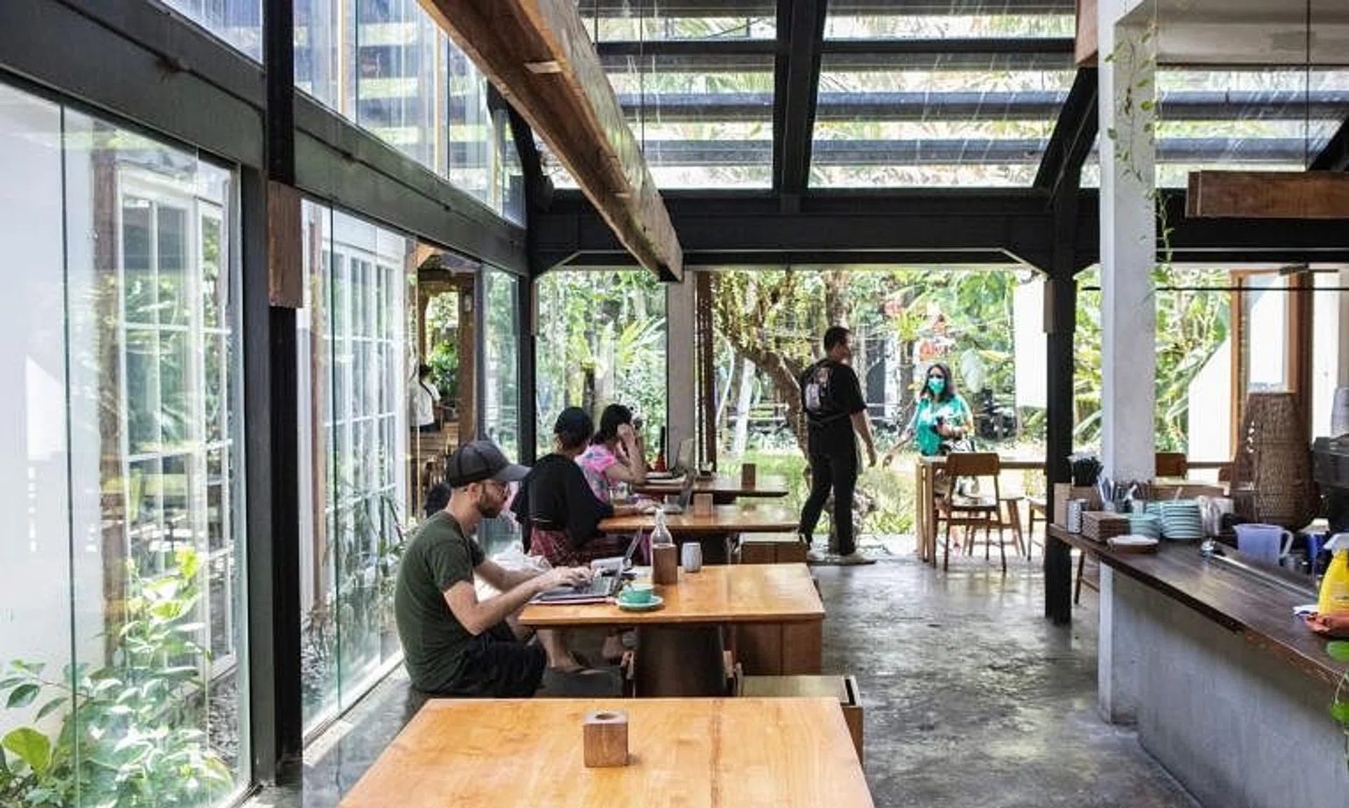 Customers work on laptops at a cafe in the Seminyak area of Bali, Indonesia, on Oct 29, 2021. 