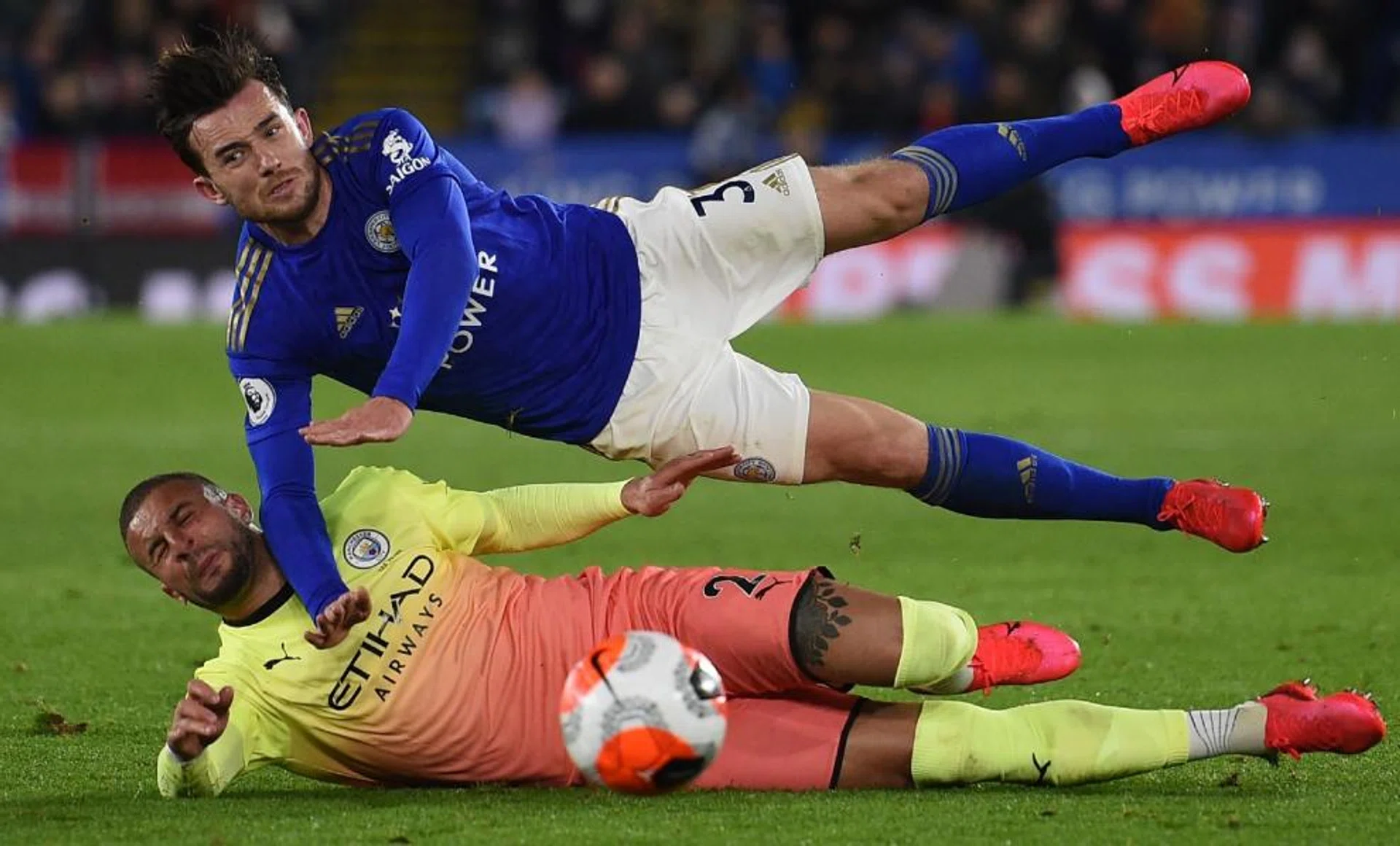 Manchester City's Kyle Walker and Leicester City's Ben Chilwell vying for the ball during an English Premier League match.