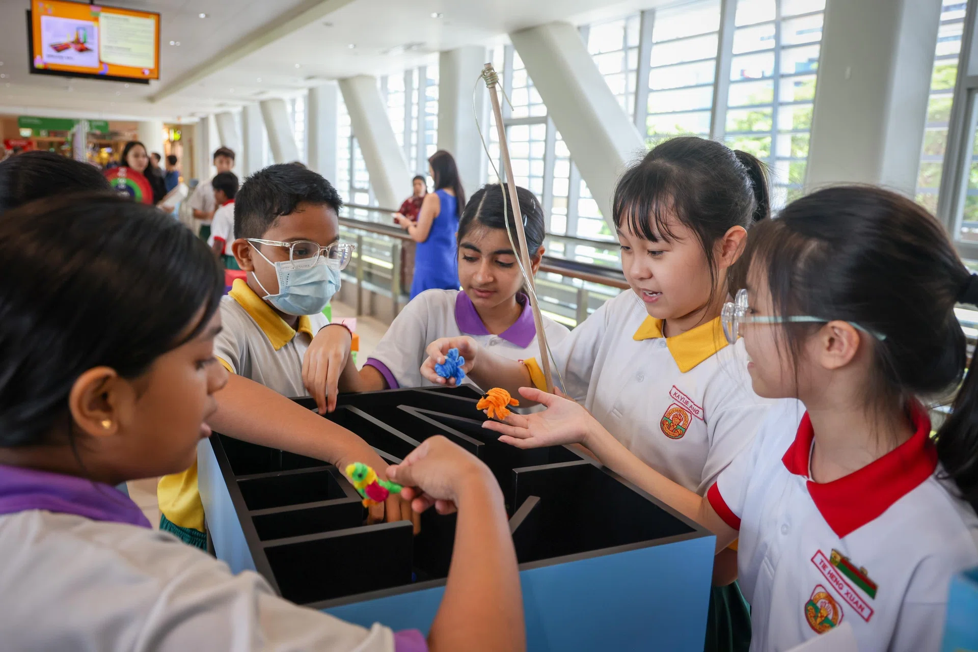 Princess Elizabeth Primary School pupil Kaylie Ang (second from right) and her schoolmates with a game she designed to aid patients' recovery, on Sept 18.
