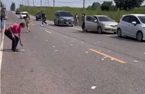 Guess what happened when money flew around on a road in Thailand...