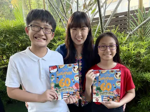 Sharon Koh, seen here with her children, authored Singapore Is 60: Celebrate With Us! to commemorate the country's birthday and also raise funds for the President's Challenge.