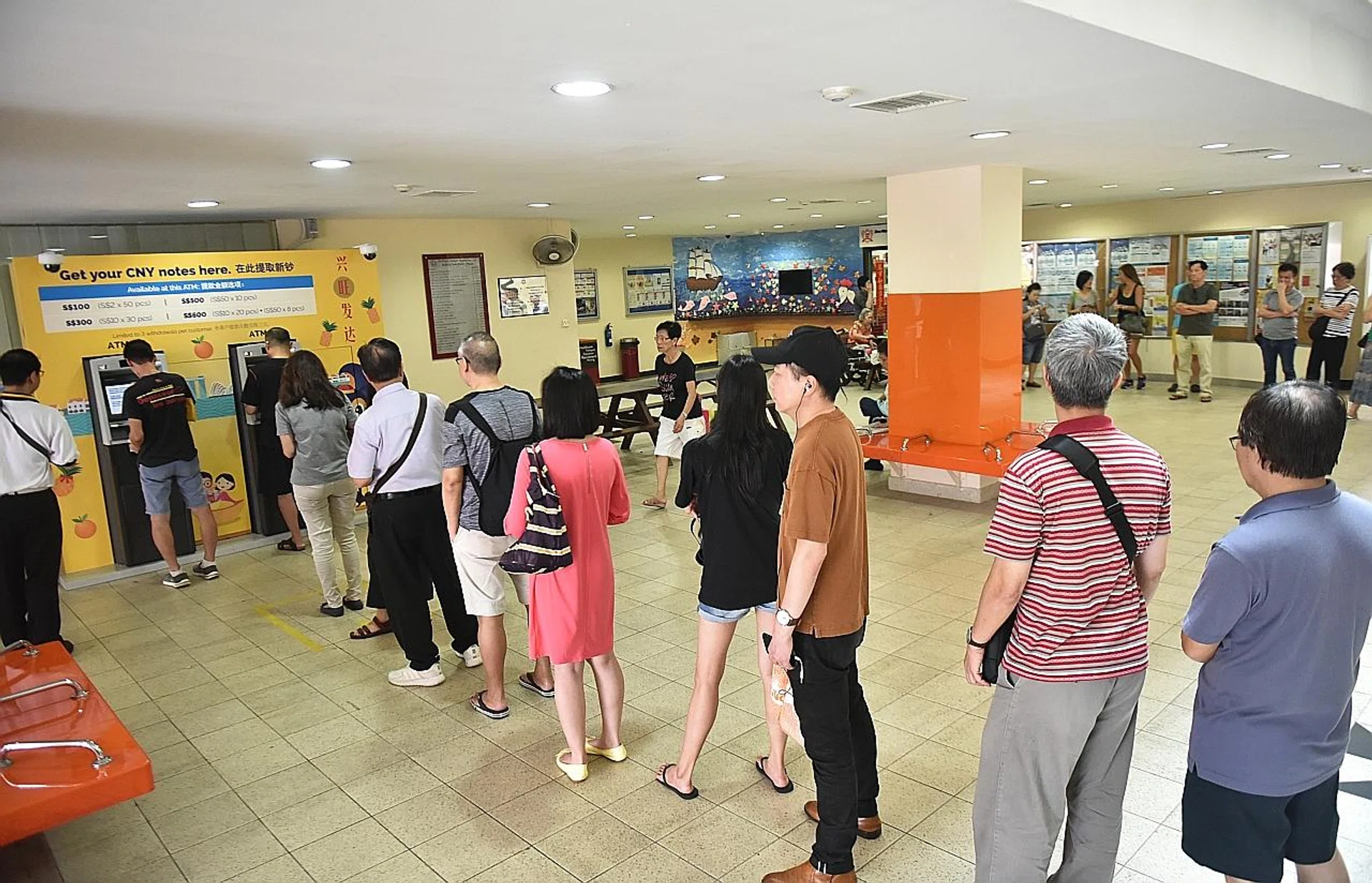 Members of the public queuing for new notes at the pop-up ATMs at Toa Payoh Central Community Club. 