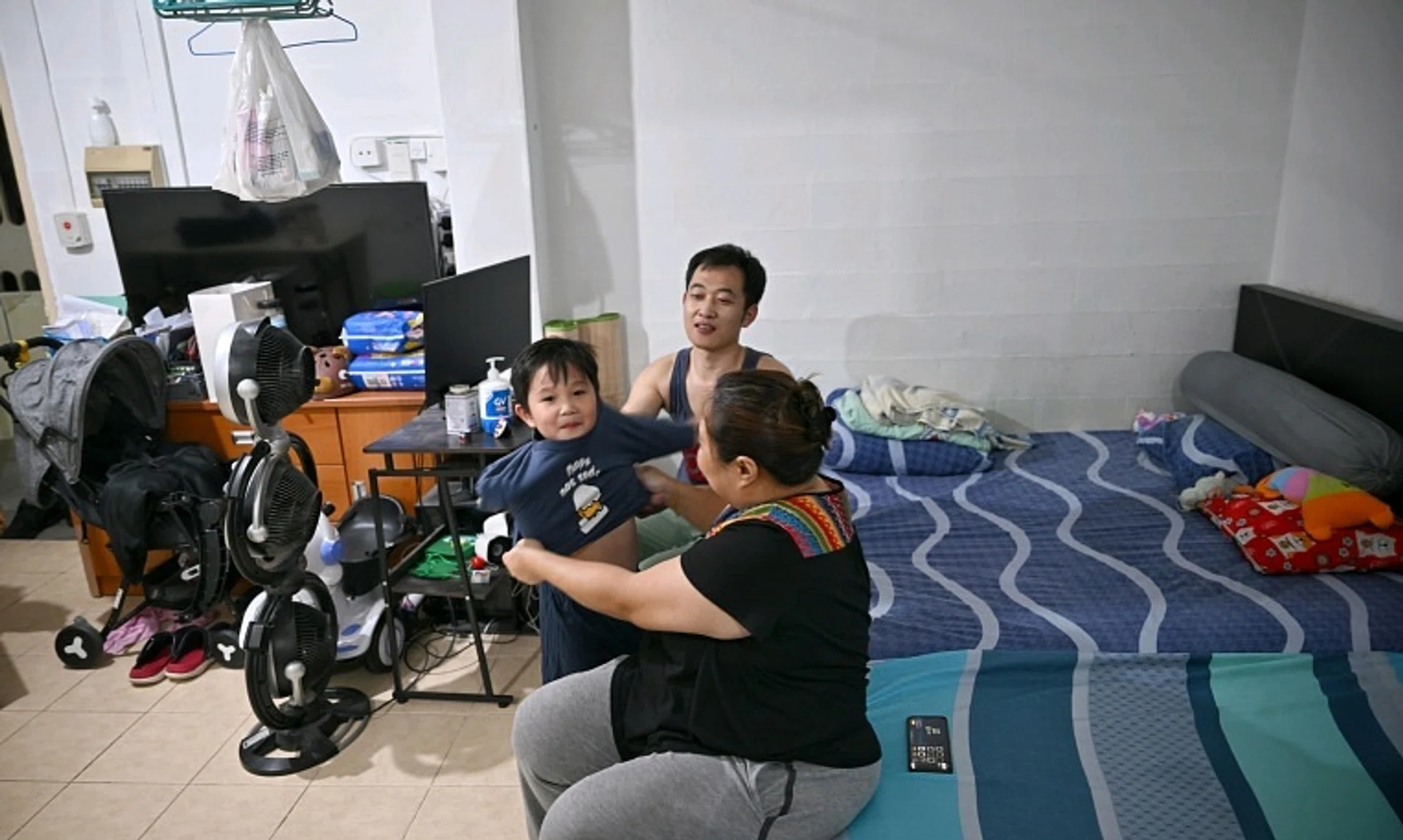Ms Choo Chang Yan, with her husband, Mr Zhao Wenbin, and their son, Zaleb, at their one-room rental flat.