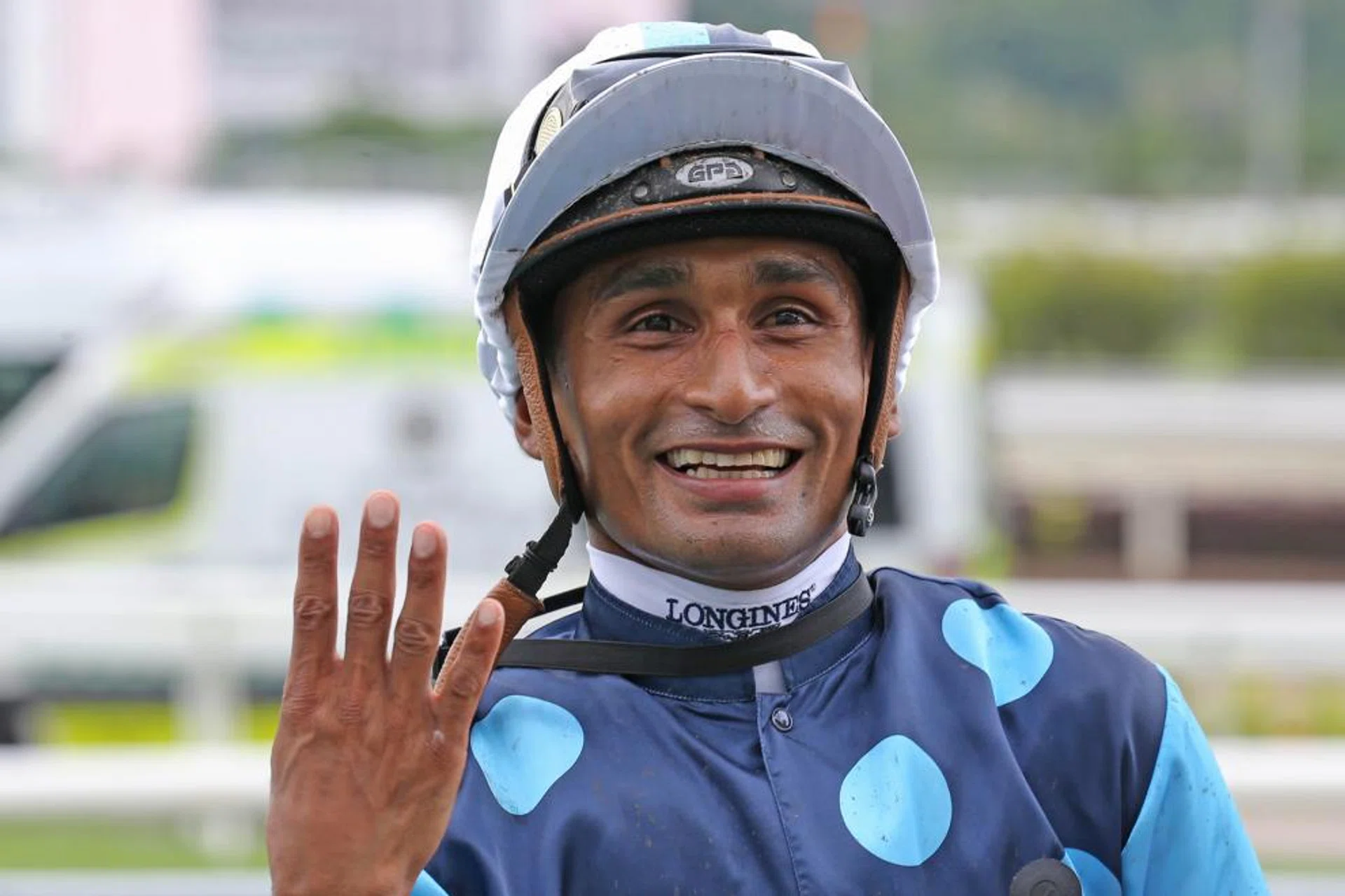 Jockey Karis Teetan showing four fingers to signify his 400th winner. 