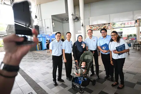 WP's East Coast team (from left) Mr Jasper Kuan, Mr Nathaniel Koh, Mr Yee Jenn Jong, Mr Sufyan Mikhail Putra and Ms Paris V. Parameswari meeting residents during a walkabout at Bedok Interchange Hawker Centre on April 24.