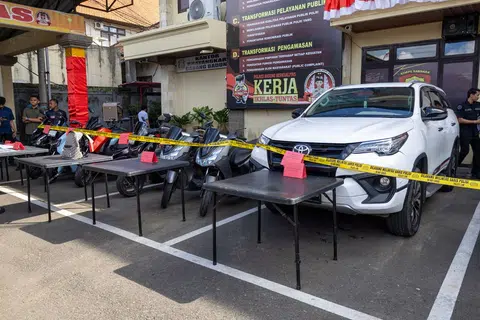Several vehicles, including the cars and motorcycles allegedly used in the escape, were displayed after they were seized as evidence.