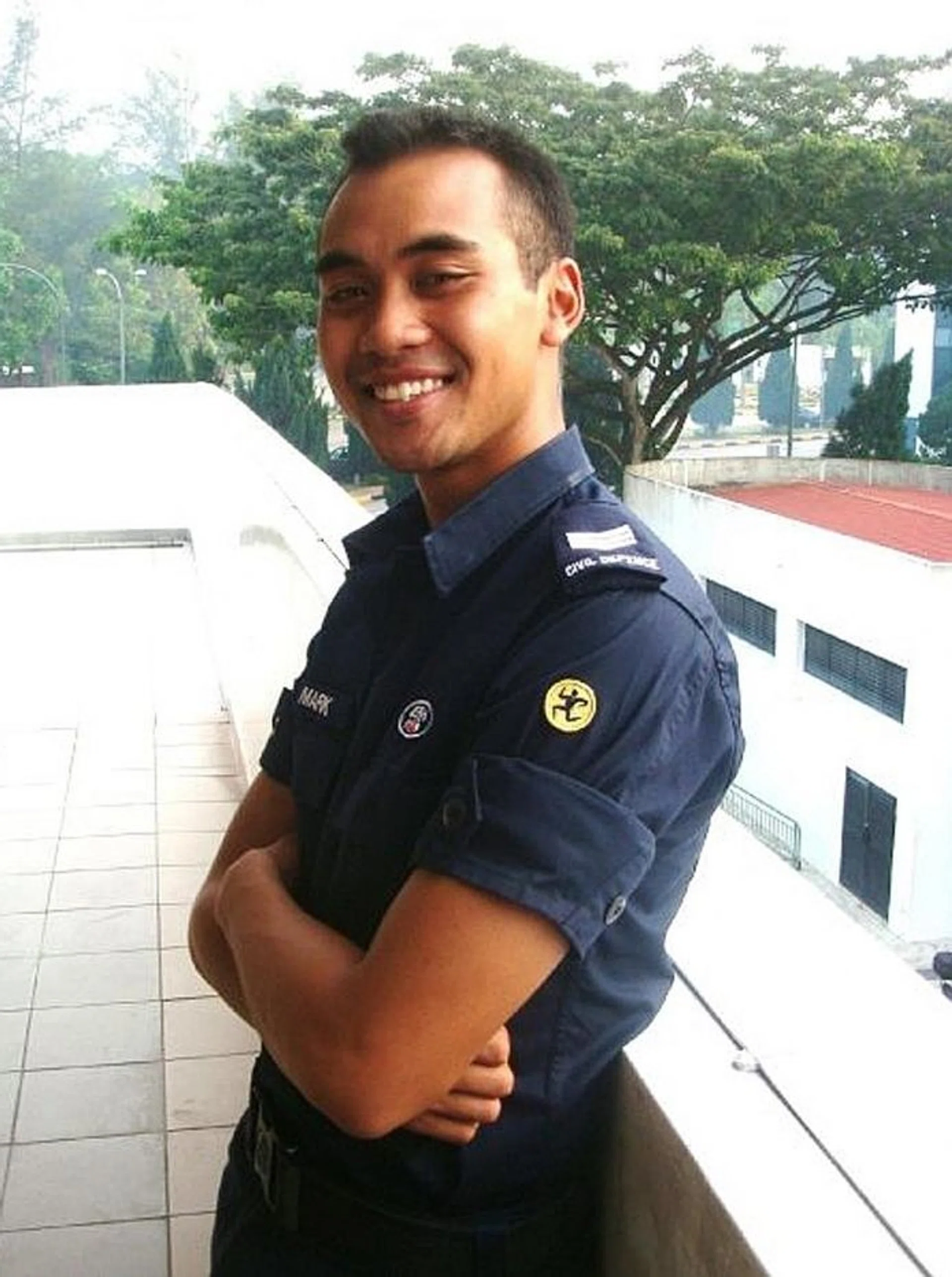 HAPPY: Mr Mark Adam Collins in a photograph taken just after he graduated from the Section Commander Course at the Civil Defence Academy with the rank of sergeant.