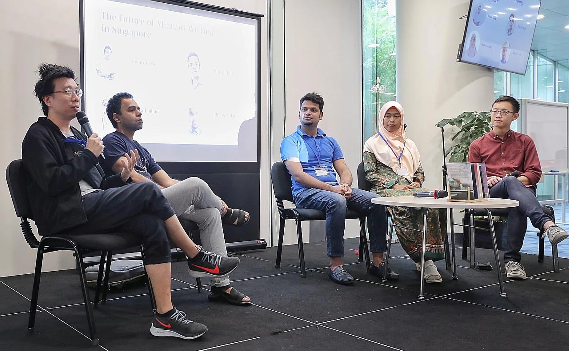 (From far left) Books Actually co-founder Kenny Leck, Migrant Worker Poetry Competition organiser Shivaji Das, migrant poets Bikas Nath and Yulia Endang, and moderator Theophilus Kwek taking part in a panel discussion. 