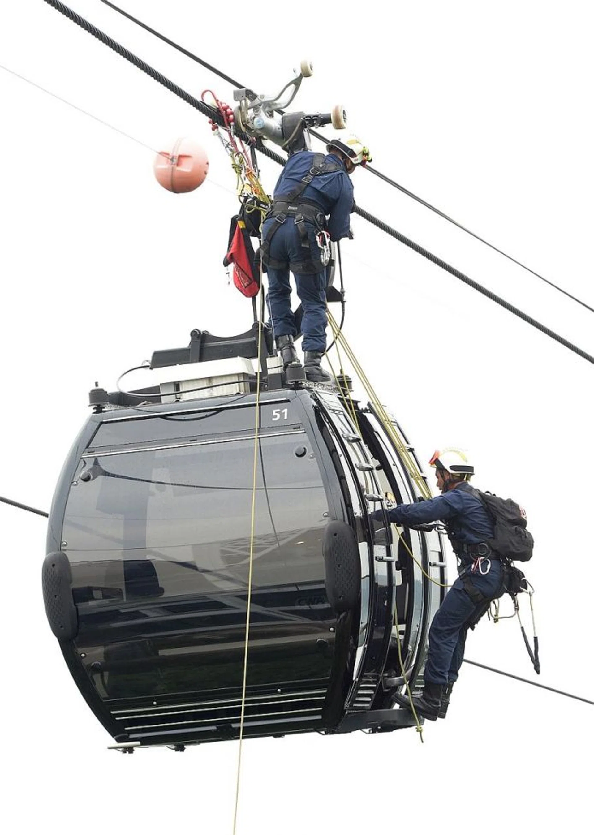 SAFE: An SCDF rescuer making his way to the top of the cable car. Another rescuer rappels down to the cable car and hooks the 'casualty' onto a harness. Then they lower 'him' down. 